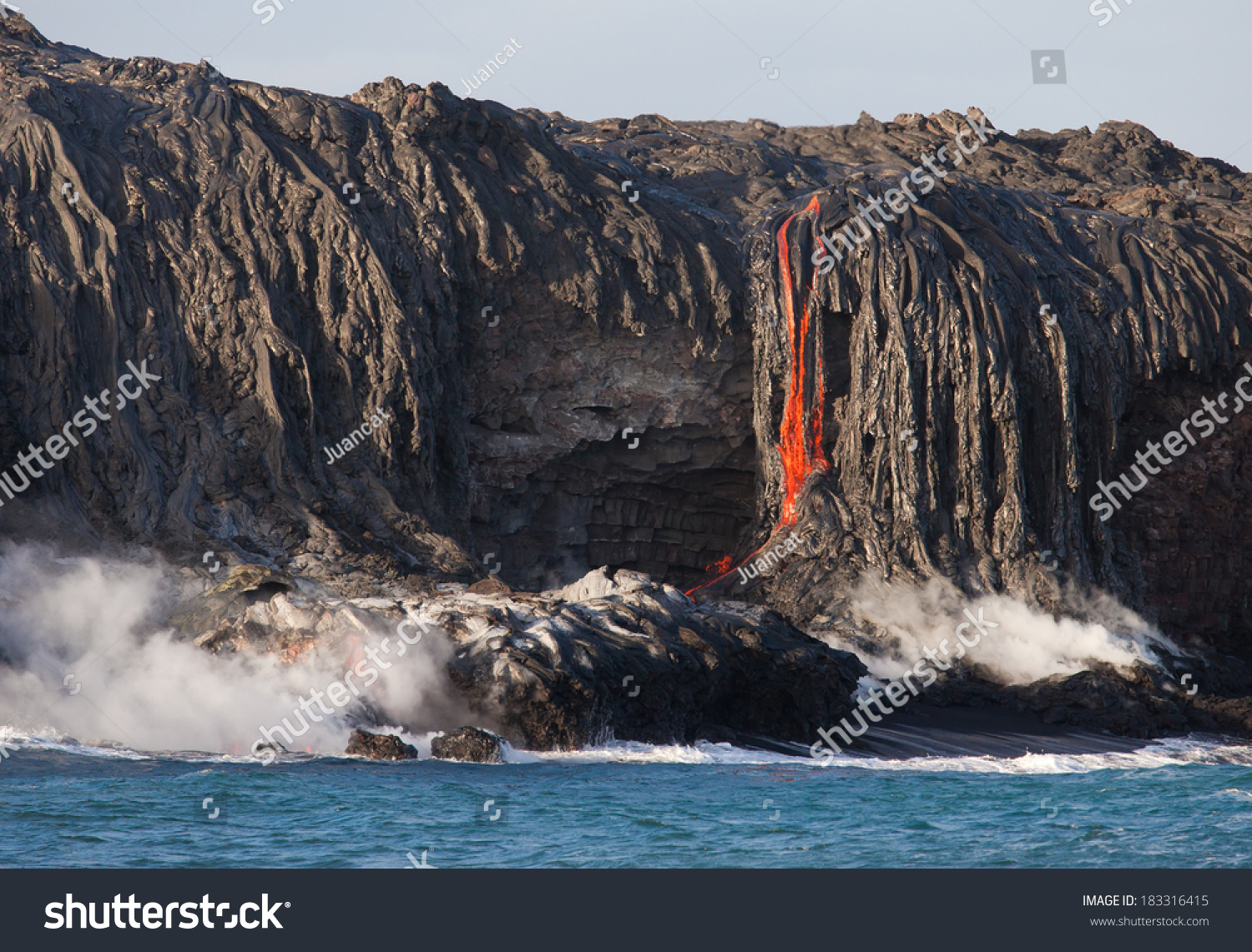 Red hot lava flowing into Pacific Ocean on Big Island  Hawaii 