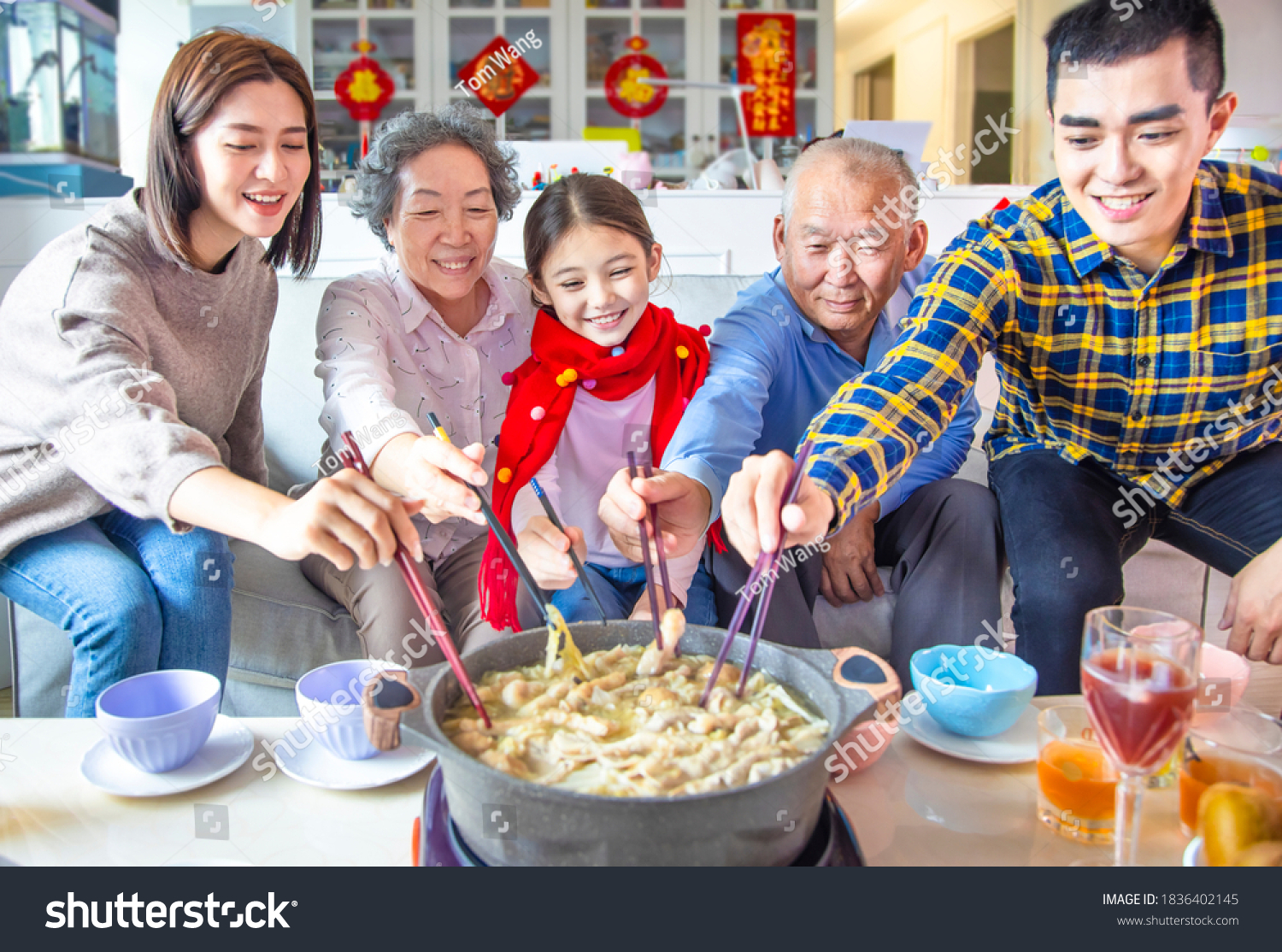 happy asian family having dinner and celebrating chinese new year at home