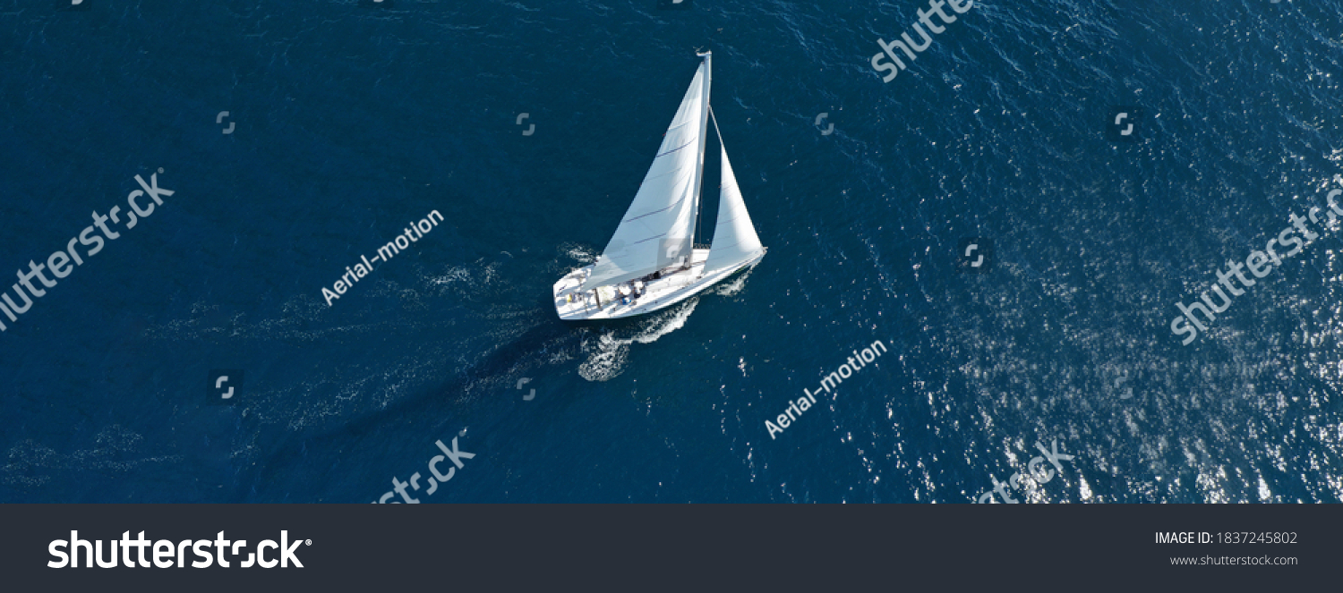 Aerial drone photo of beautiful sailboat cruising deep blue open ocean Mediterranean sea