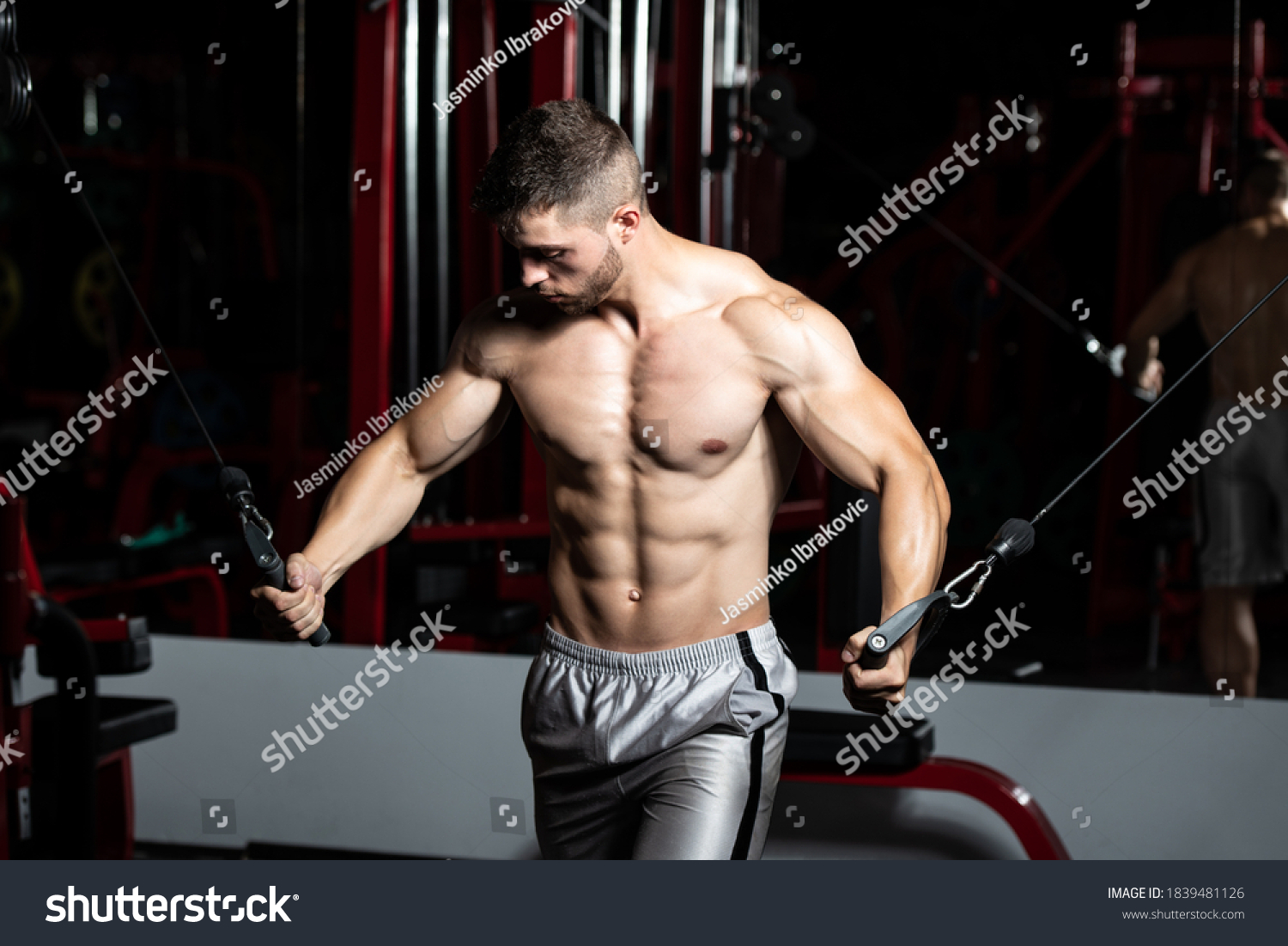 Handsome Muscular Fitness Bodybuilder Doing Heavy Weight Exercise For