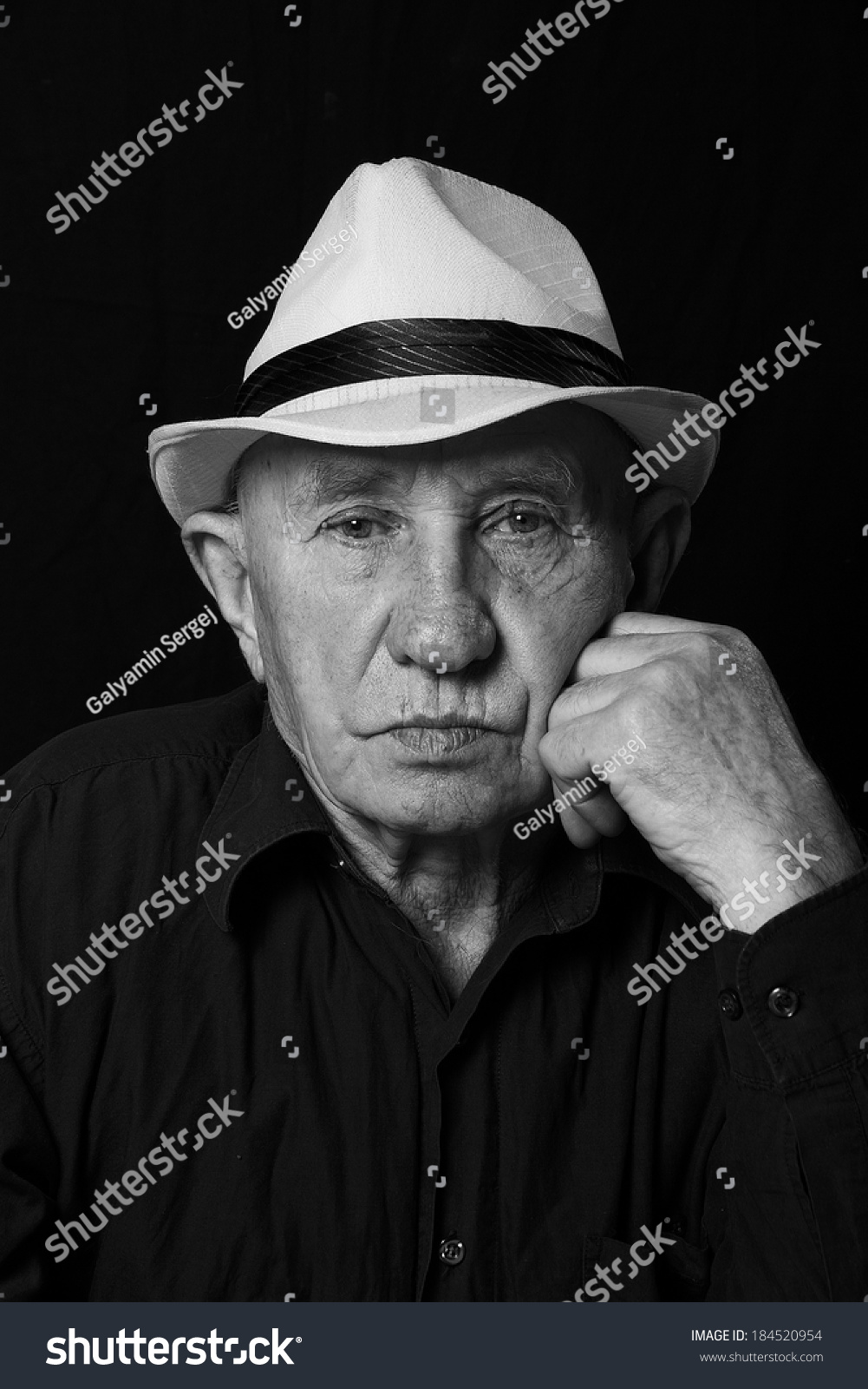 photo senior male retired wearing a hat on black