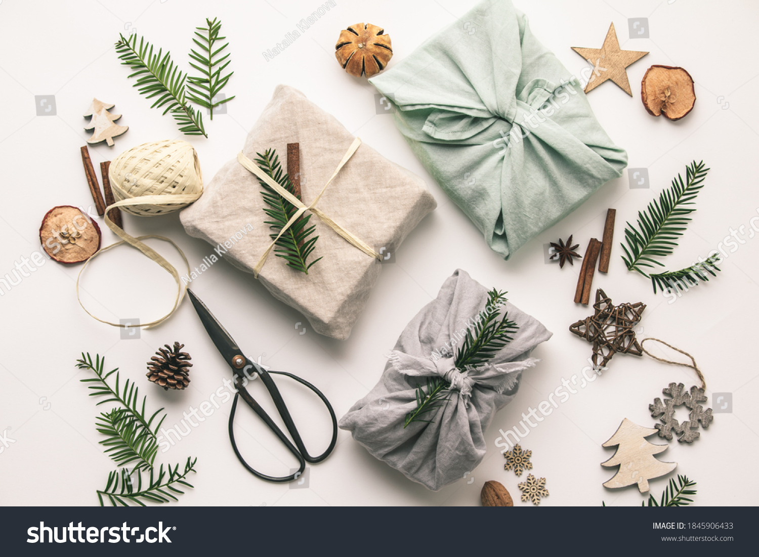 Fabric wrapped gifts and wooden Christmas decorations