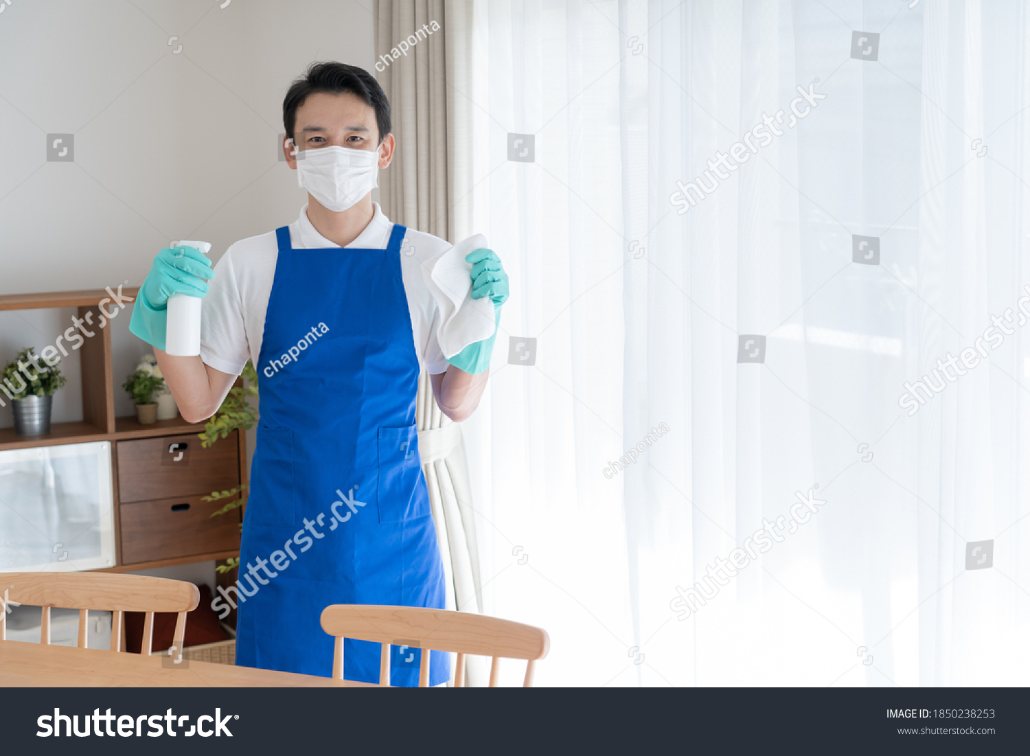 Asian man wearing an apron