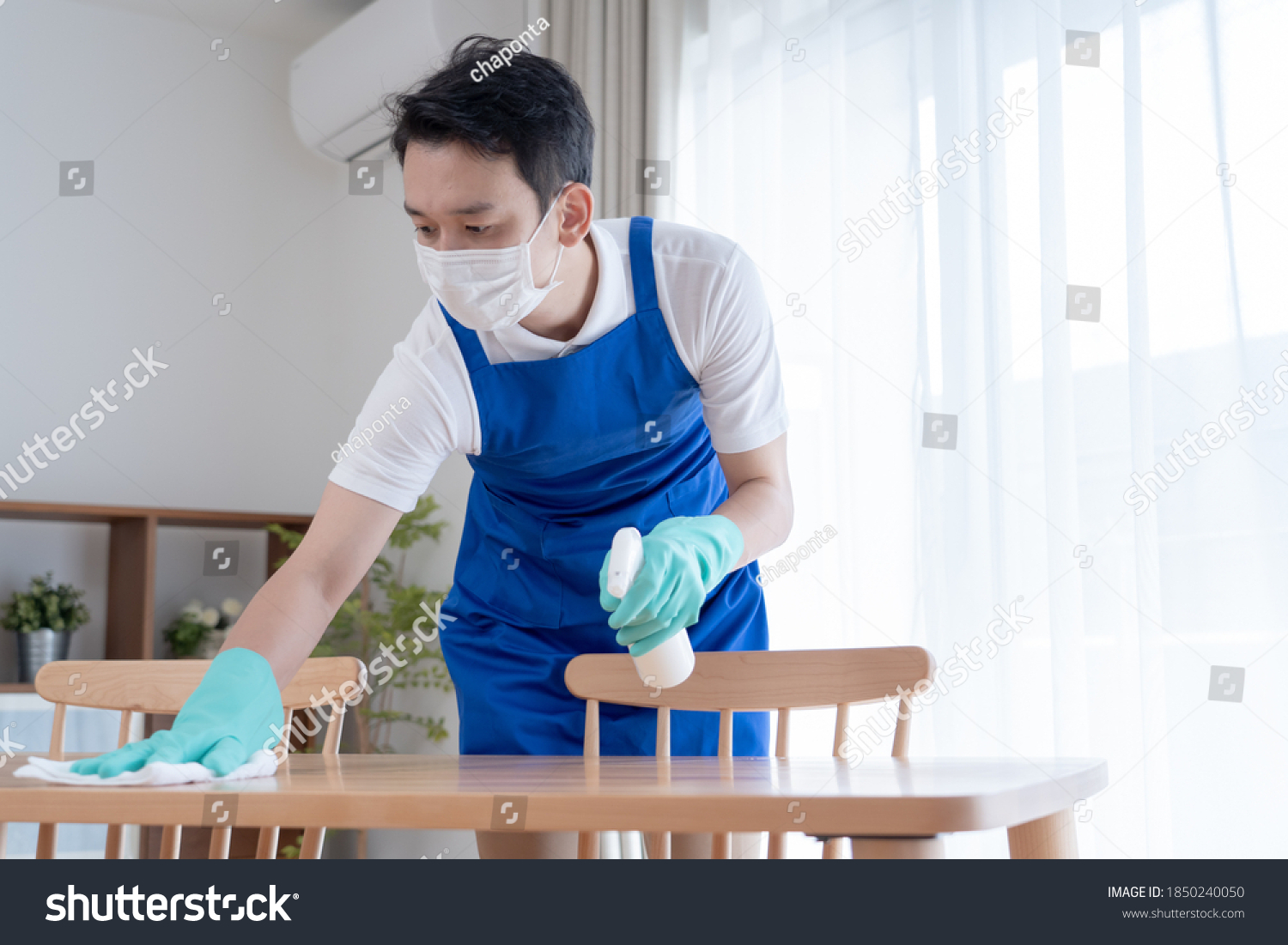 Asian man wearing an apron