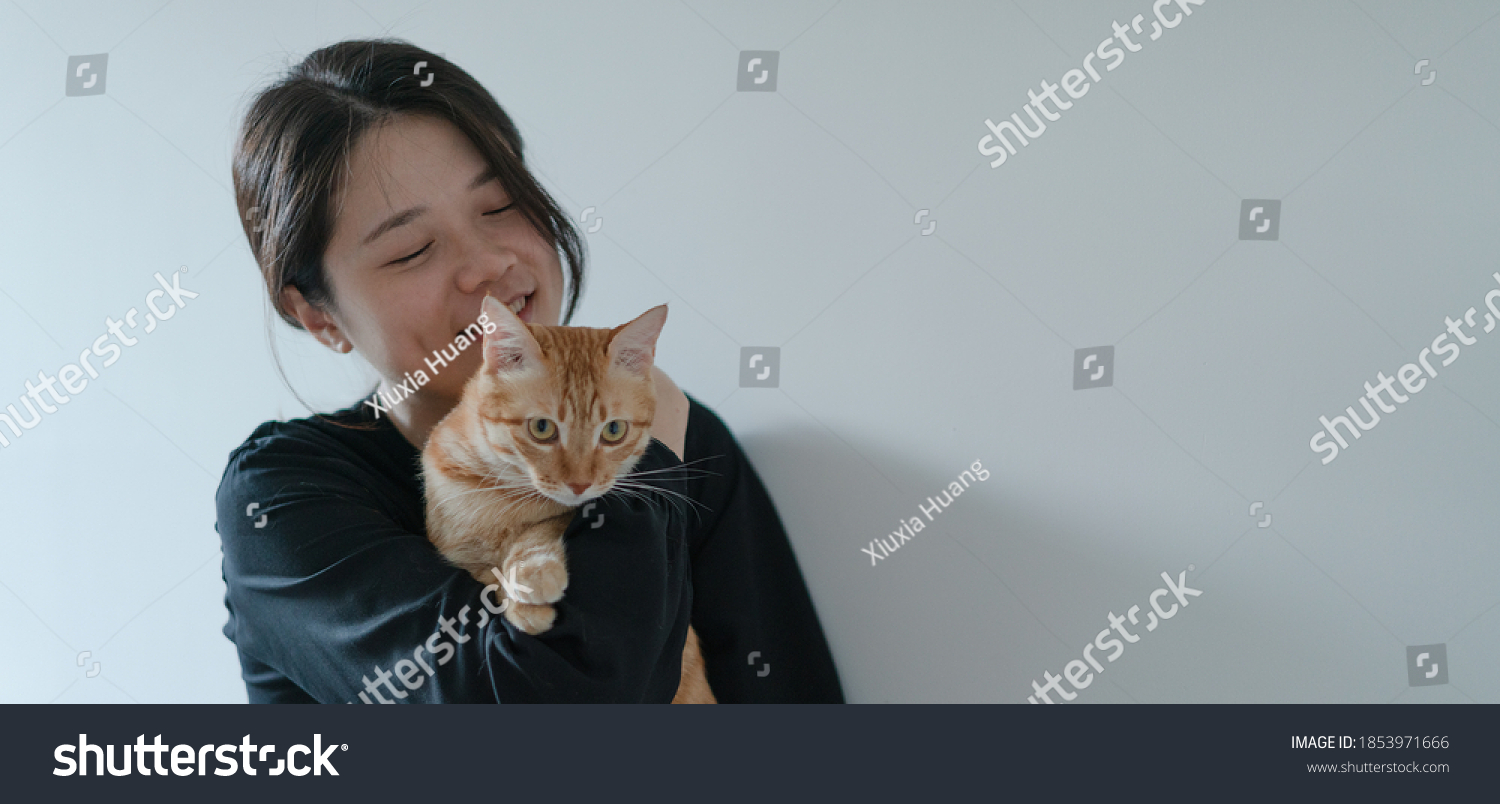 happy woman hugging her cat