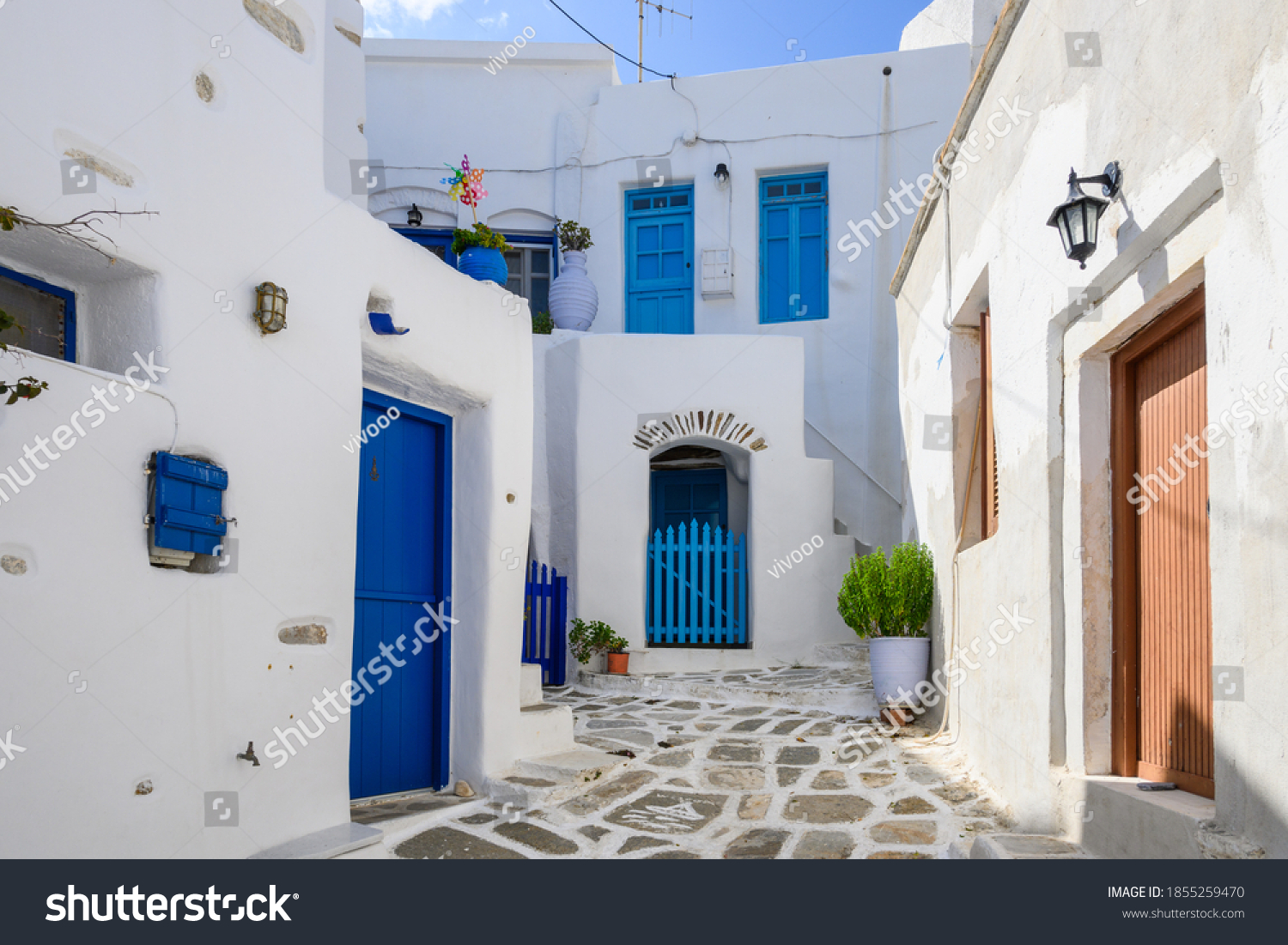 Typical Greek house with blue windows and doors on whitewashed street in beautiful Lefkes village on Paros island. Cyclades  Greece