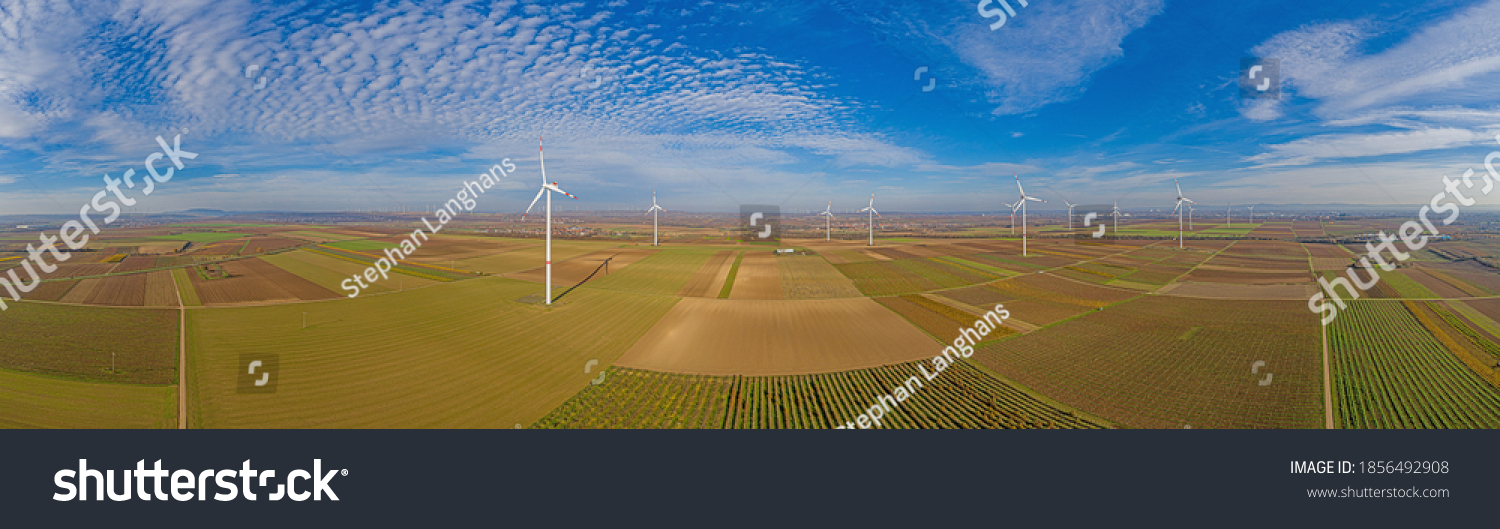 Panoramic aerial photo of a wind farm in Germany during the day with blue sky and light clouds