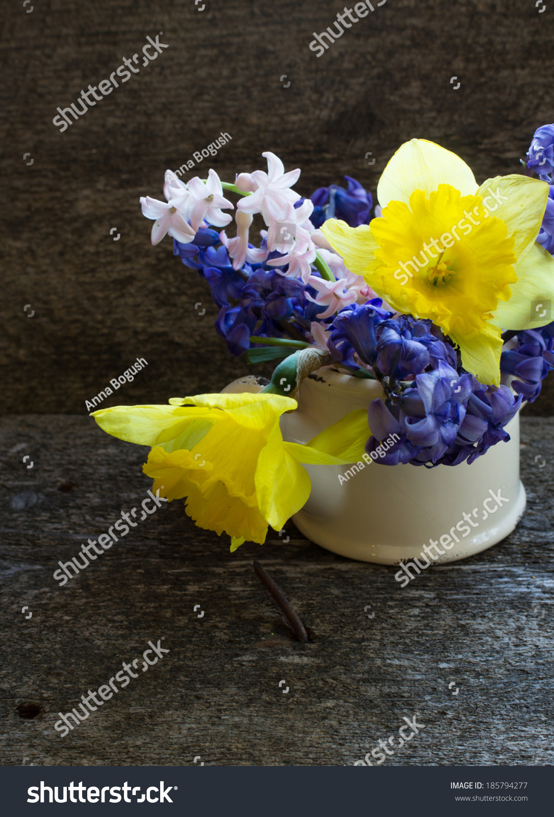 pitcher with hyacinth and narcissus flowers in a vase