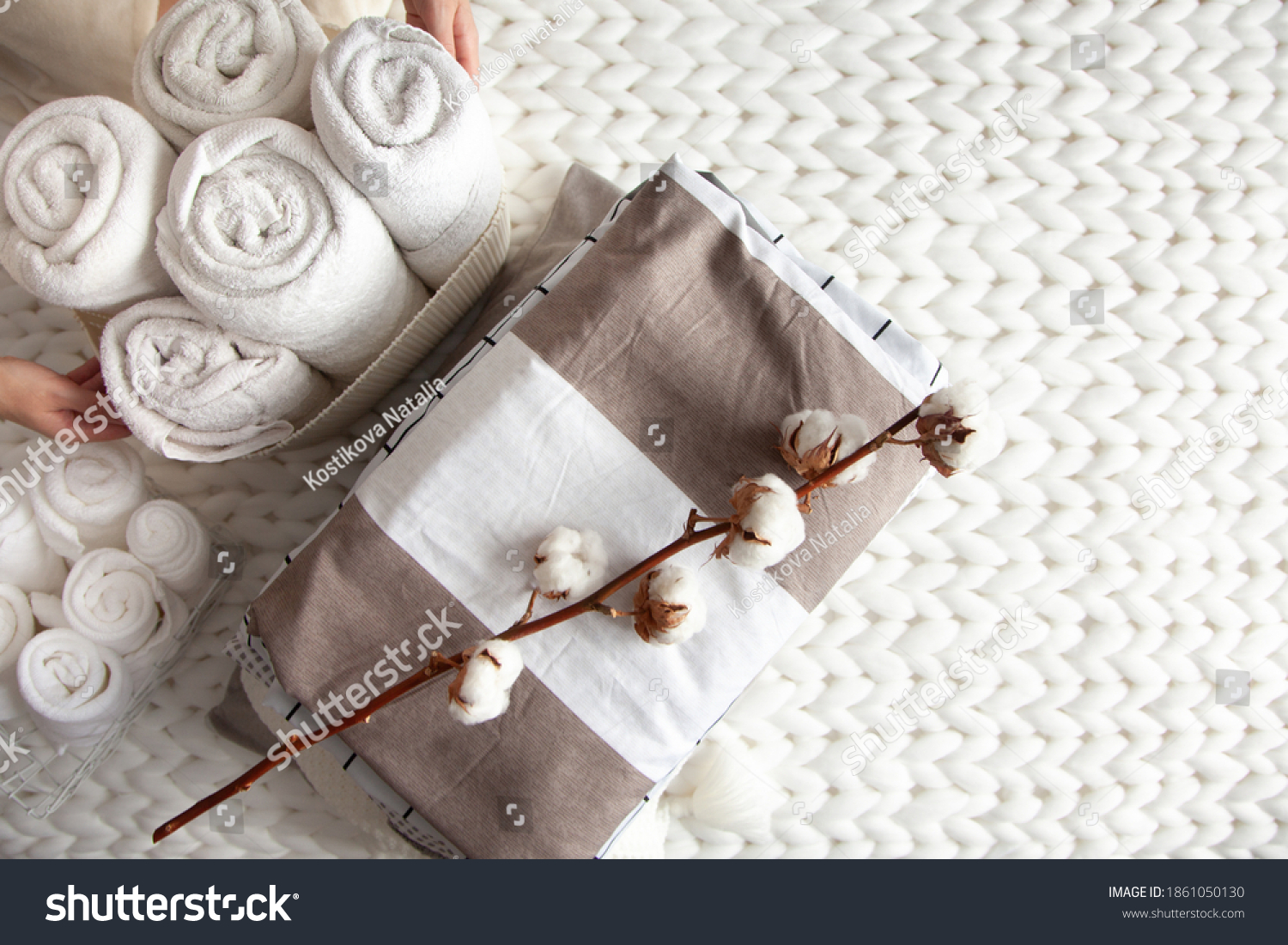 well-groomed-woman-hand-holding-a-cotton-branch-with-stack-of-neatly