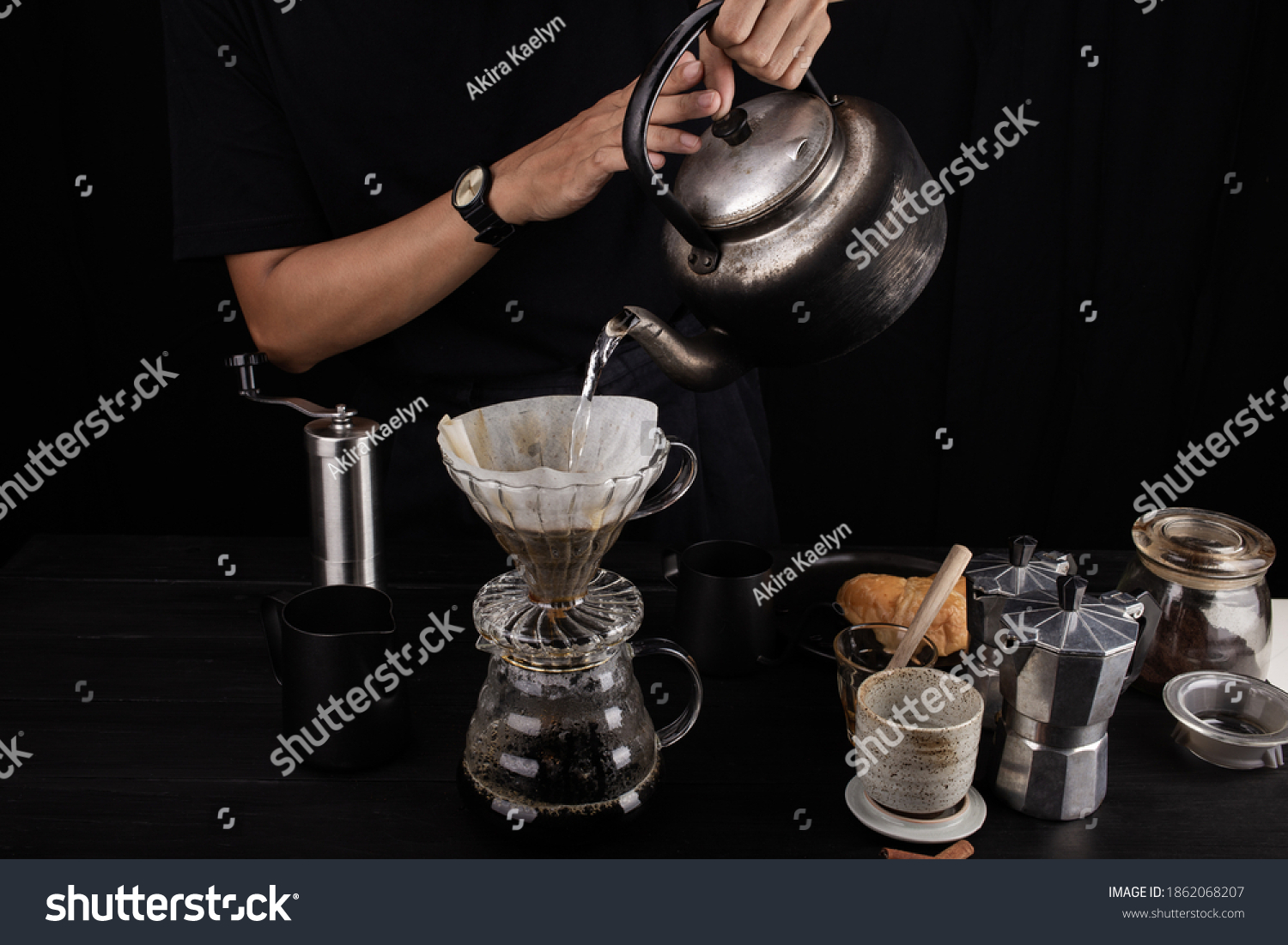 hand-poured water of dripping coffee on the cup