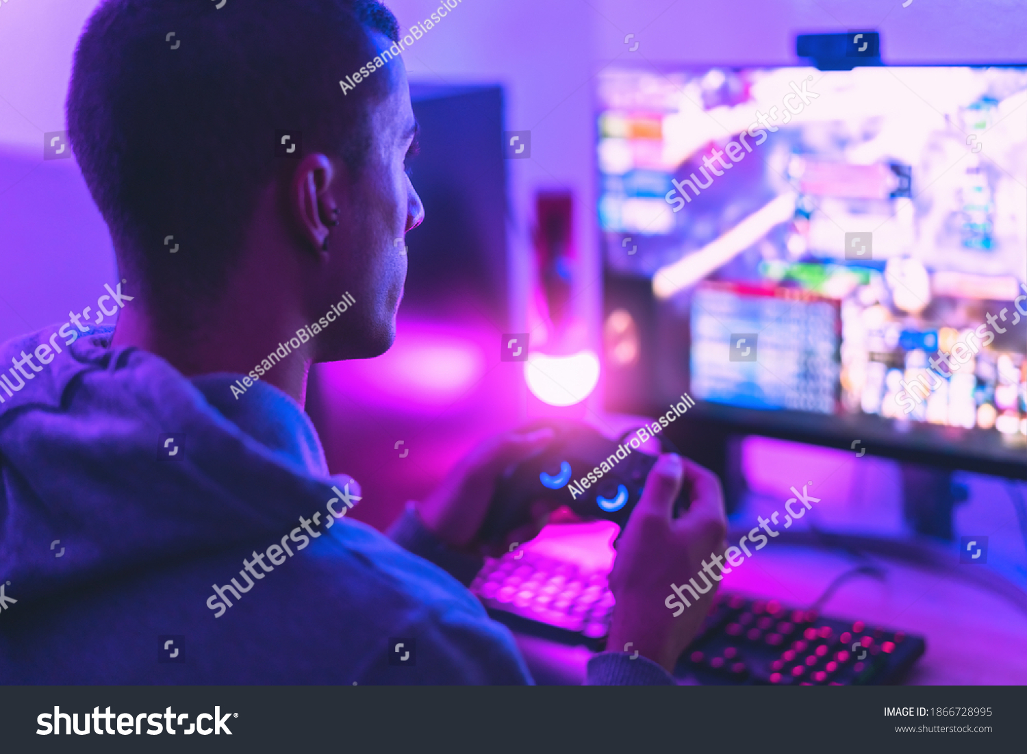 Young gamer playing online video games while streaming on social media - Youth people addicted to new technology game