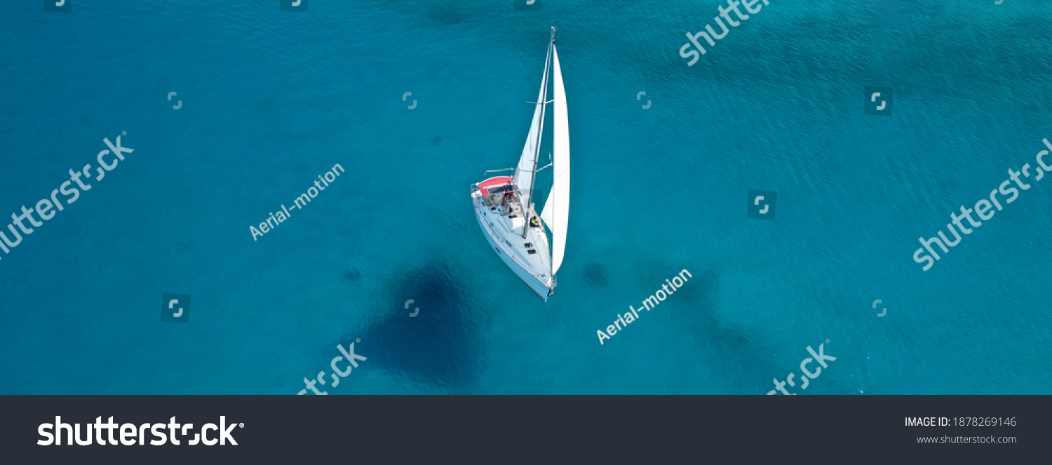 Aerial drone ultra wide photo of beautiful sail boat sailing in turquoise Ionian island sea