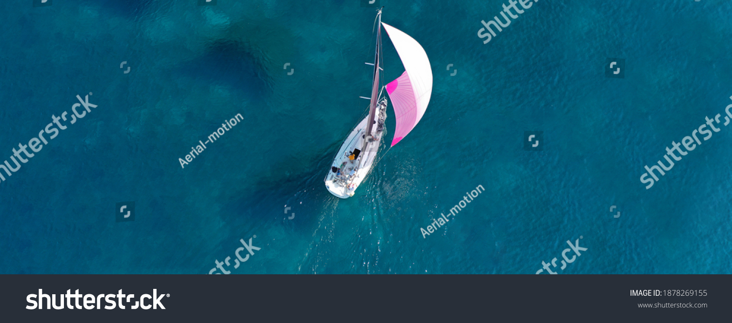 Aerial drone ultra wide photo of beautiful sail boat sailing in turquoise Ionian island sea