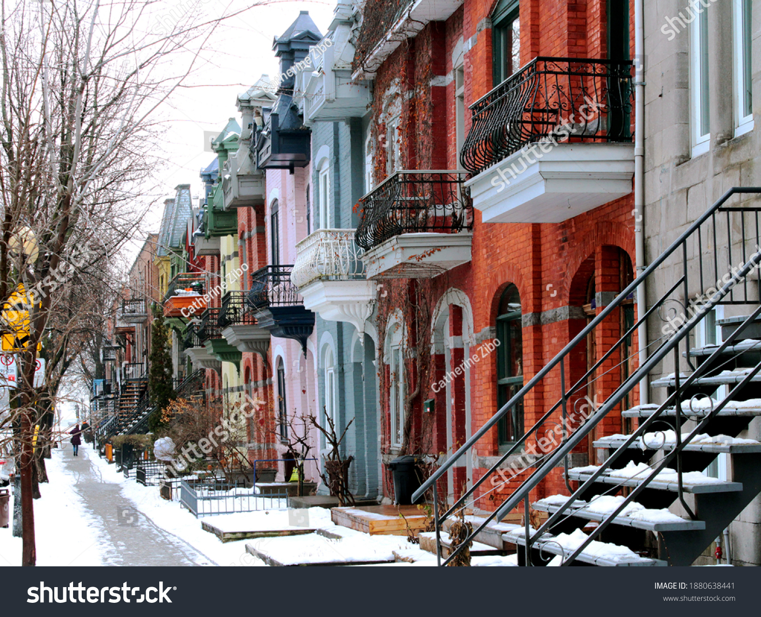 Beautiful houses of old historical Montreal neighborhood Plateau Mont Royal in winter season  bright painted doors.