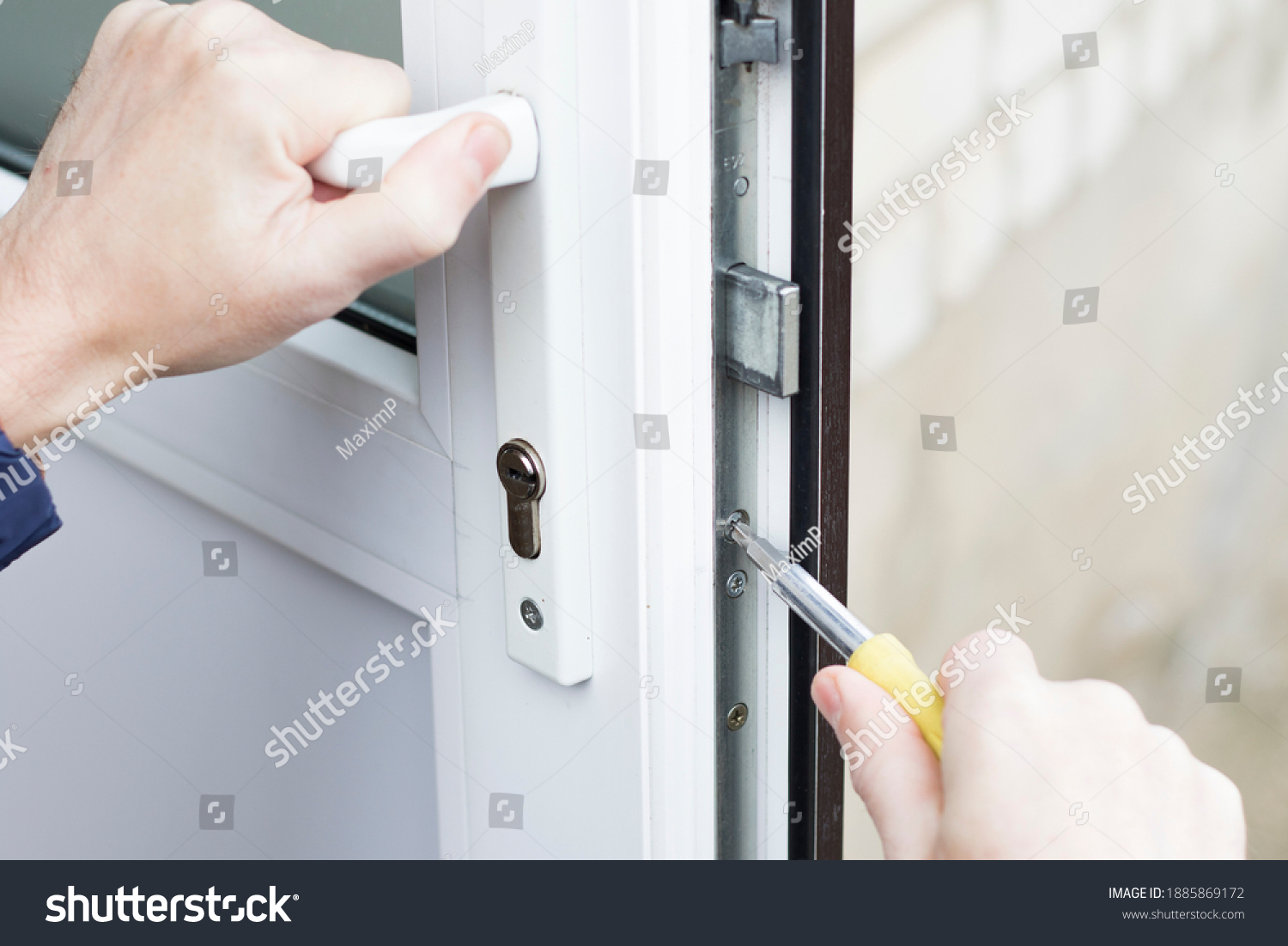 Handyman installing lock in plastic front door. Checking the lock for operability and strength.