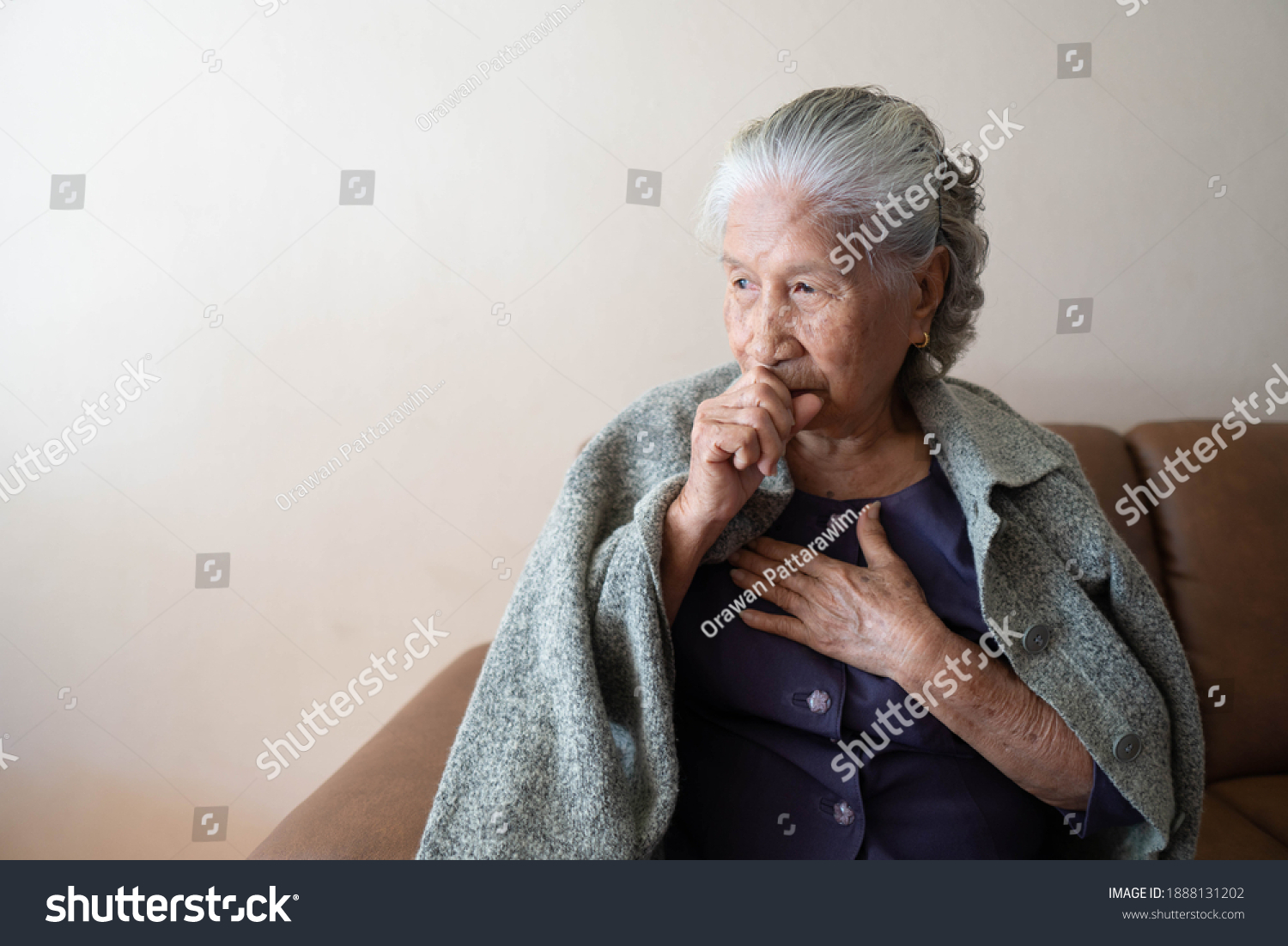 Asian senior ill female have a cough and sore throat. Causes of cough include common cold flu respiratory tract infection pneumonia bronchitis allergy or asthma. Elderly health care concept.