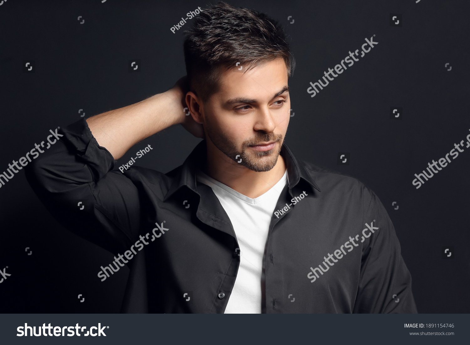 Handsome man with stylish hairdo on dark background