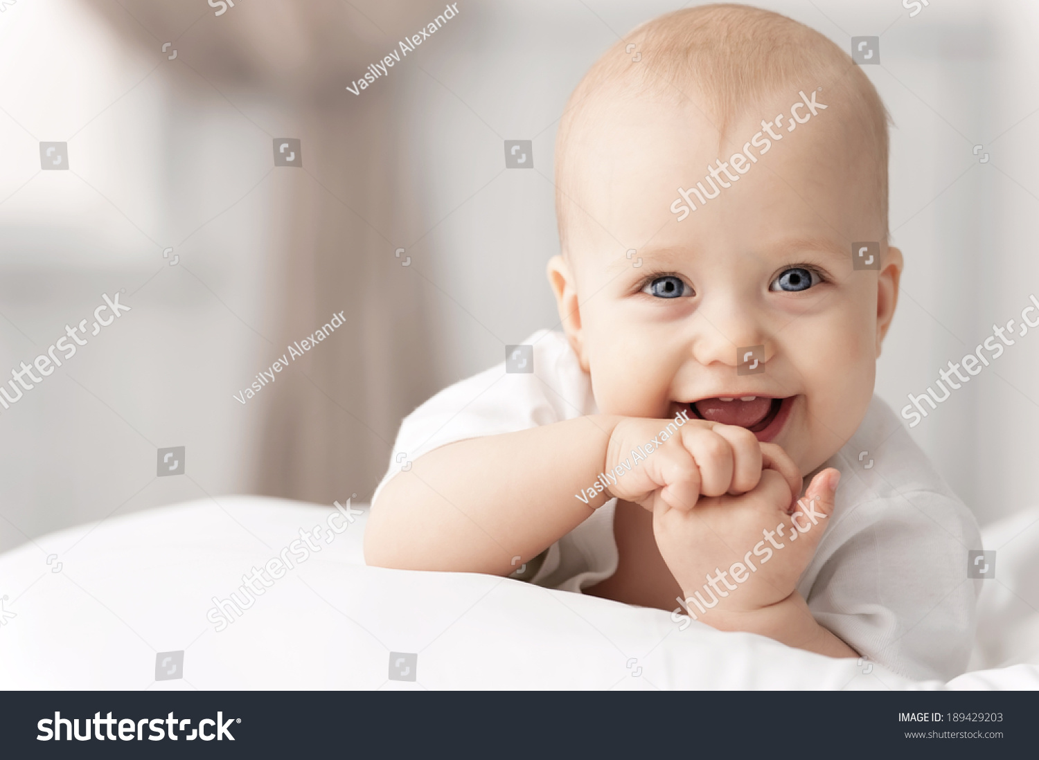 Portrait of a crawling baby on the bed in her room