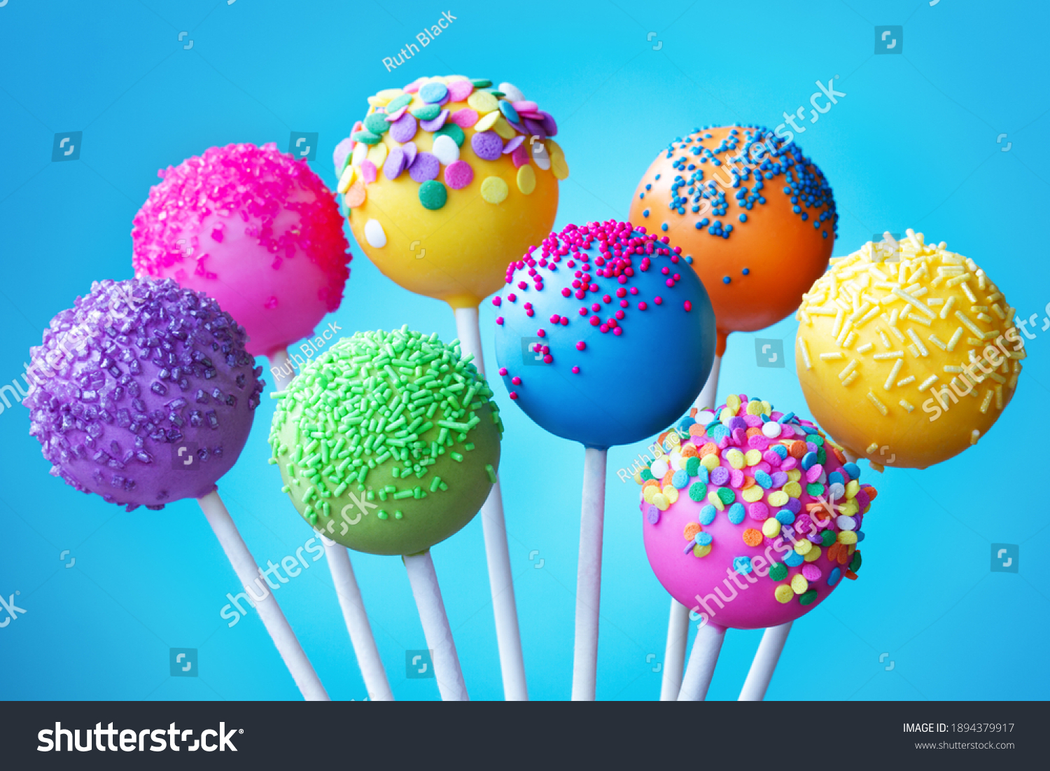 Brightly colored cake pops on a blue background