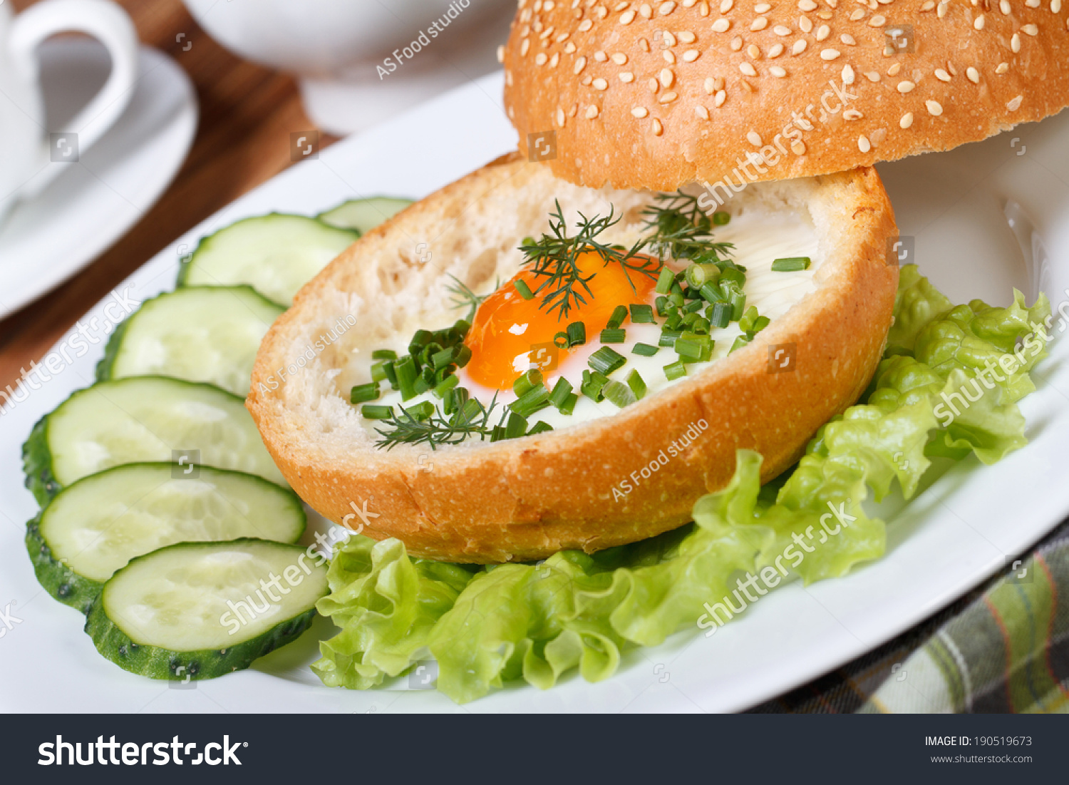 Breakfast: sandwich with baked chicken eggs close-up on a plate. horizontal 