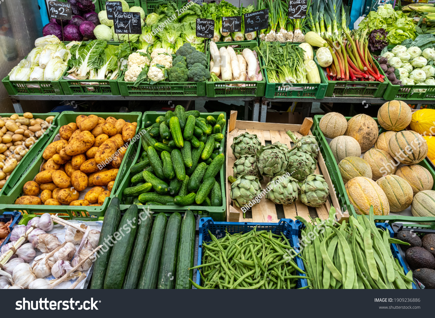 different kinds of salad and vegetables for sale at a market