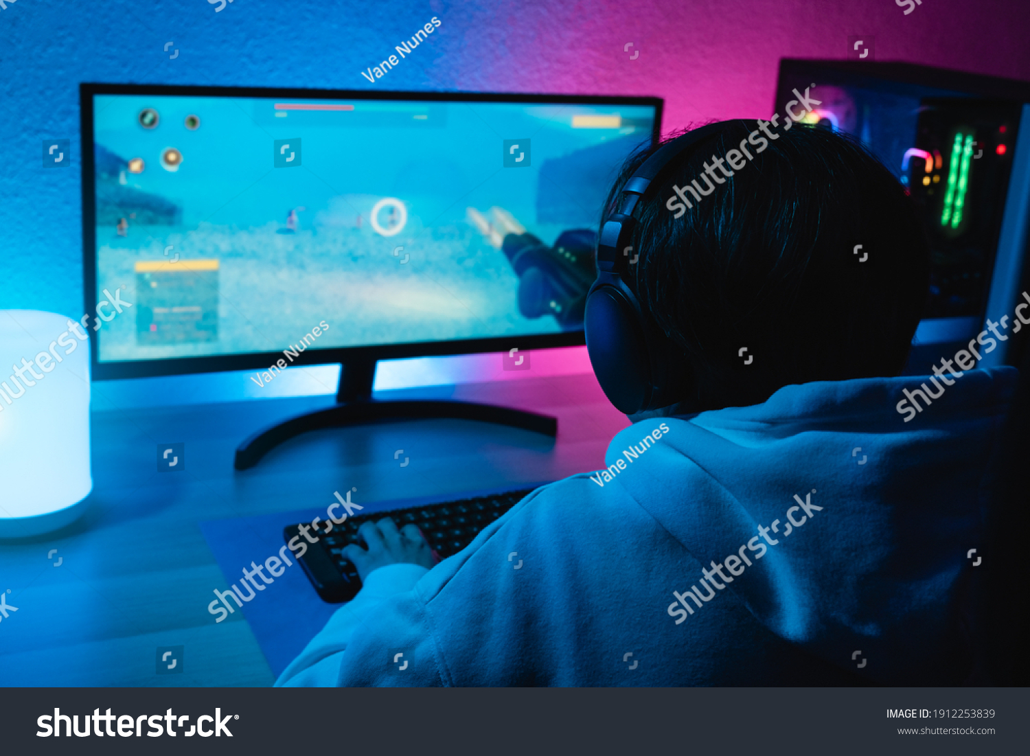Girl playing shooter online video game - Technology trend concept - Main focus on headphones