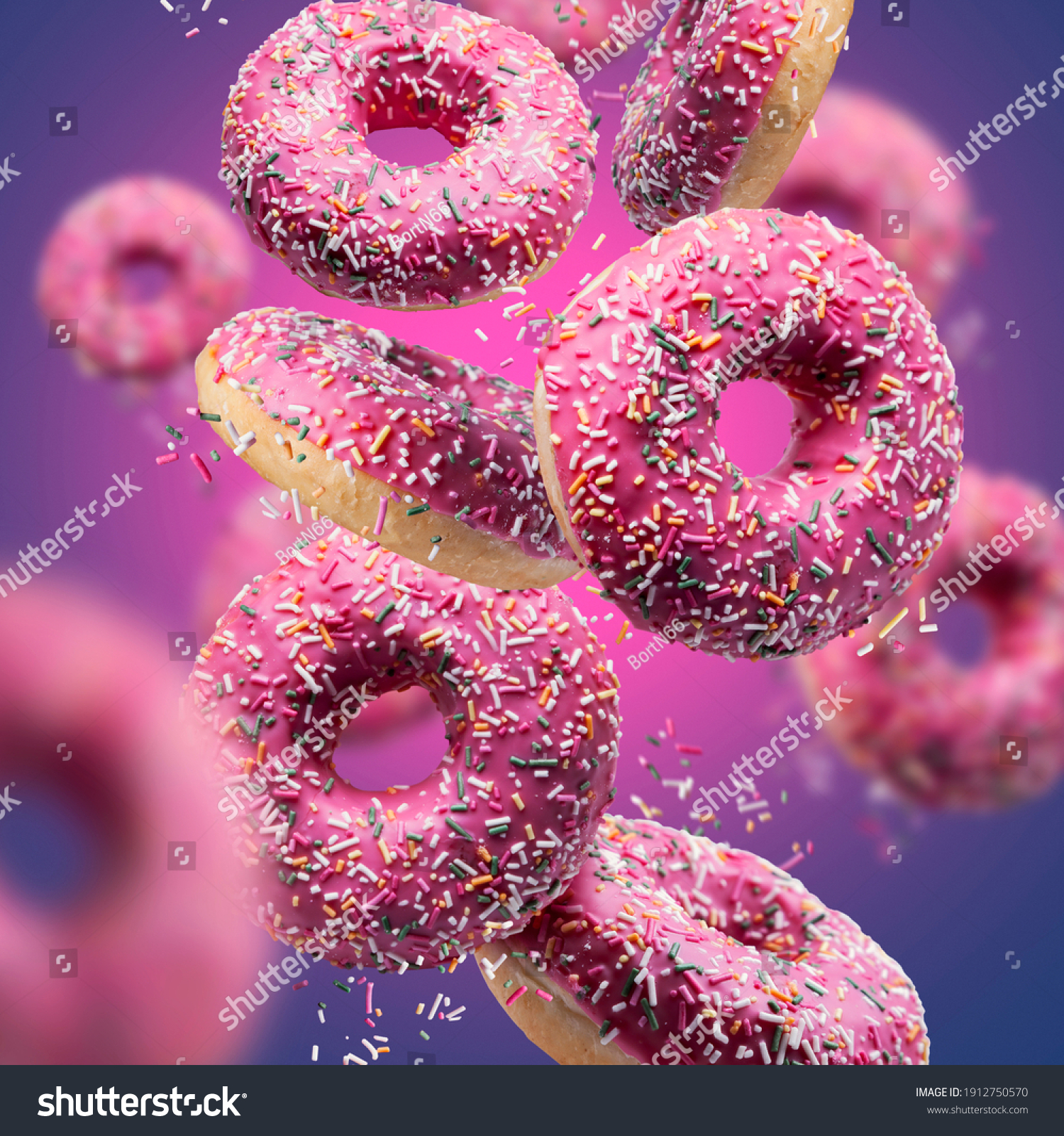 Sweet appetizing donuts on a pink-blue background. Donuts in motion.
