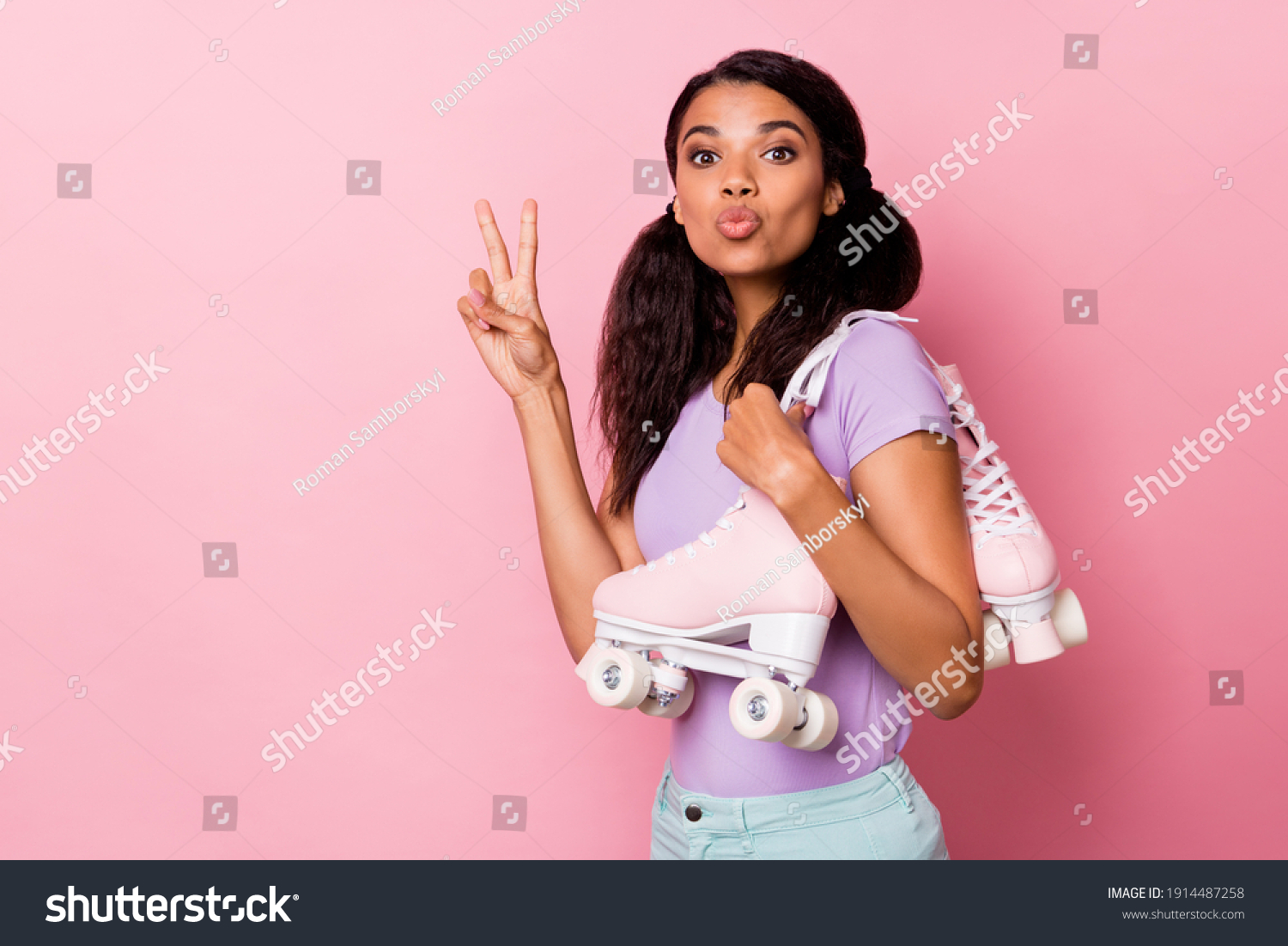 Profile side photo afro american pretty woman make v-sign wear roller skates send air kiss copyspace isolated on pink color background