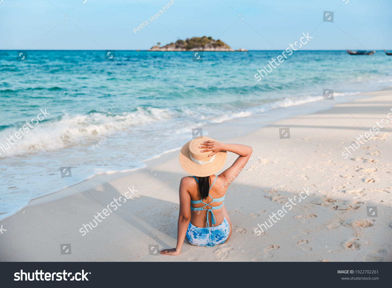 Summer travel vacation concept Traveler asian woman with bikini and hat relax on sea beach at day in Koh Lipe Satun Thailand