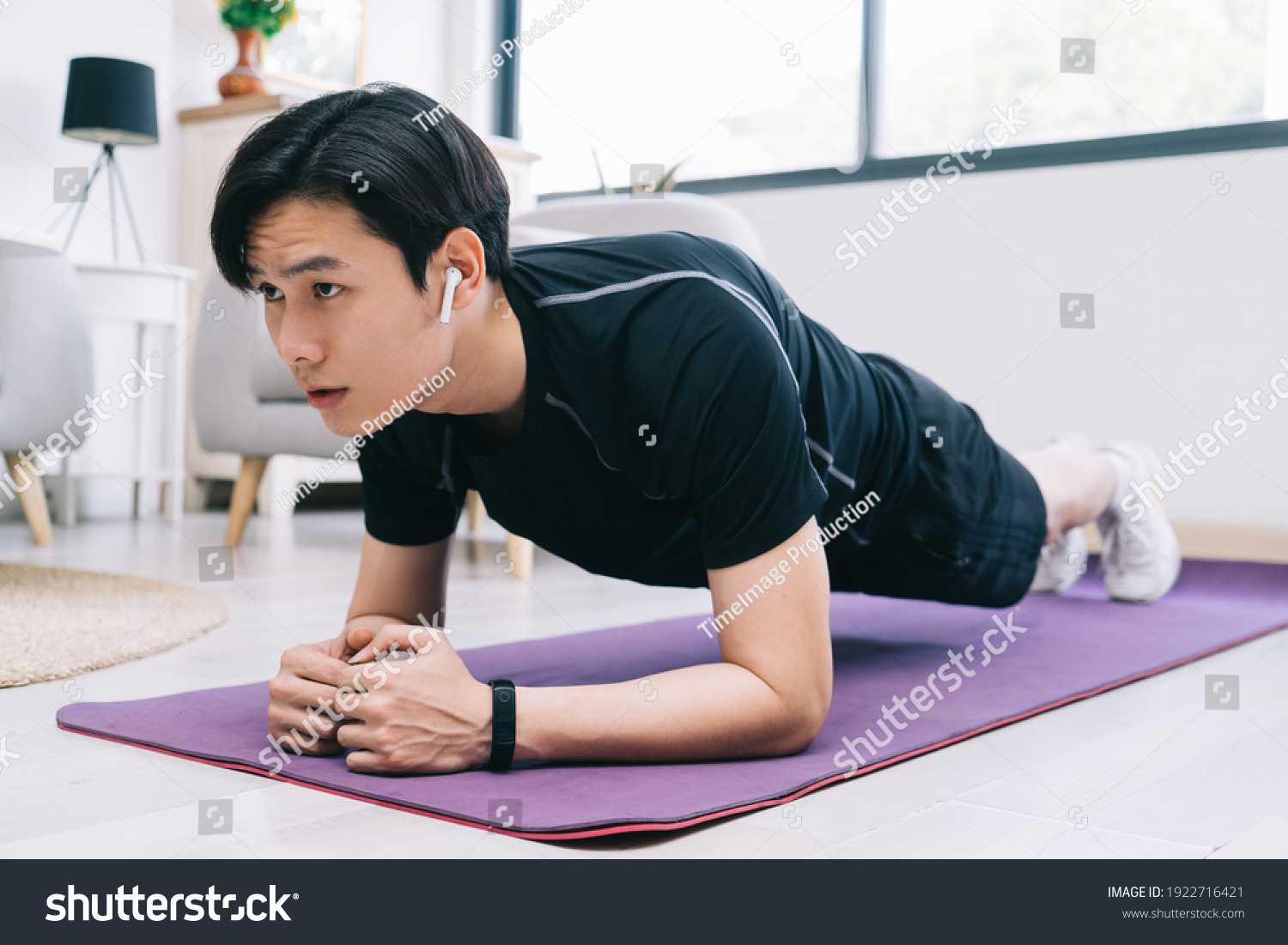 Young Asian man exercising at home
