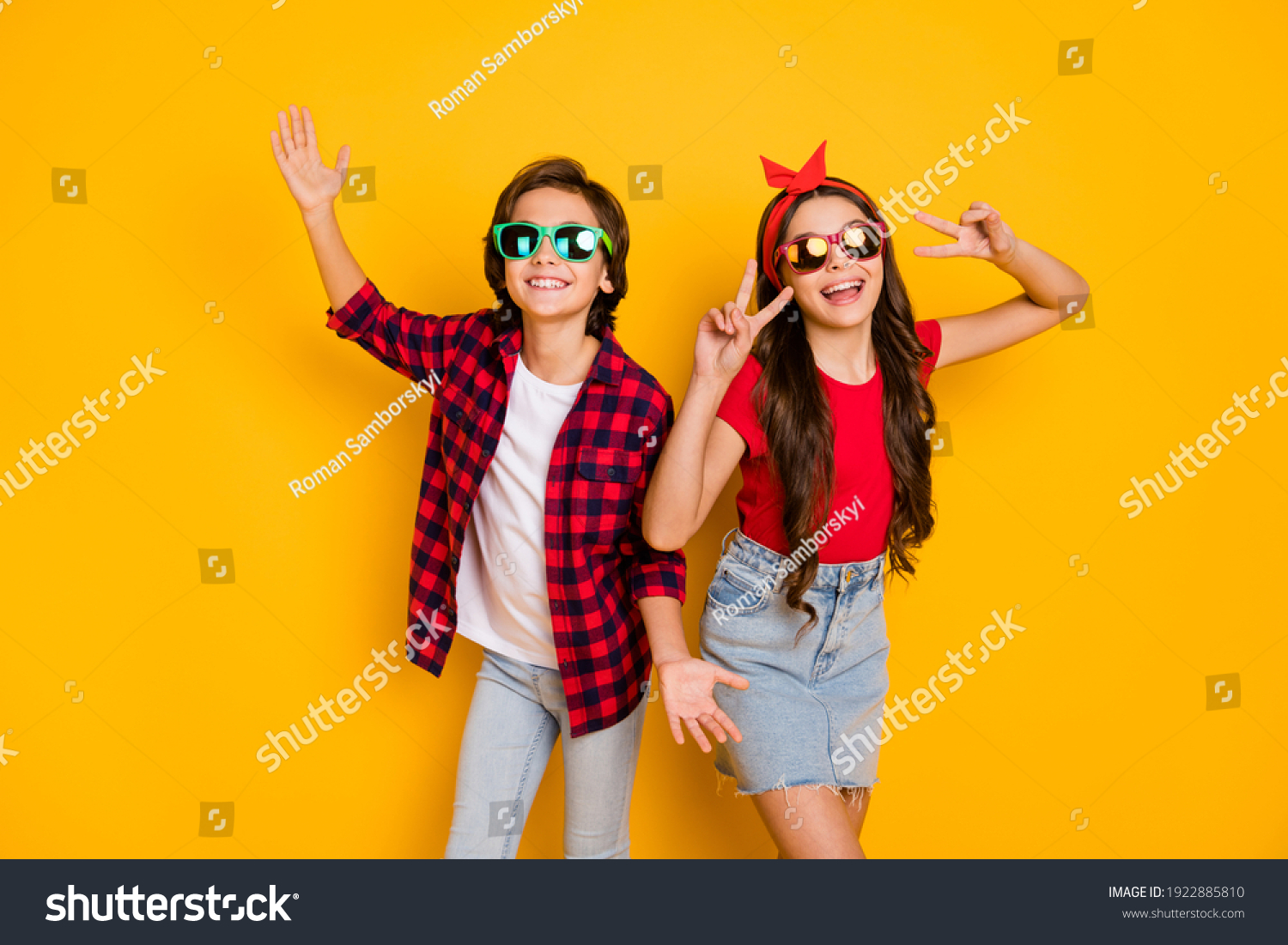 Photo of positive boy hands palms girl fingers show v-sign have good mood isolated on yellow color background
