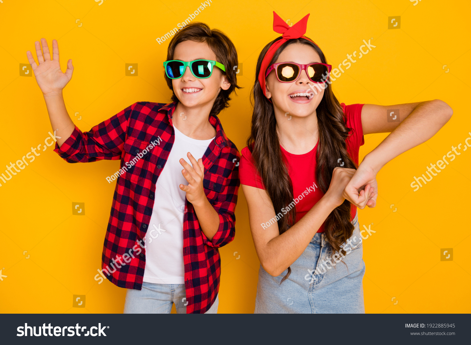 Photo of two funky kids dance having fun wear sunglass casual clothes isolated yellow color background