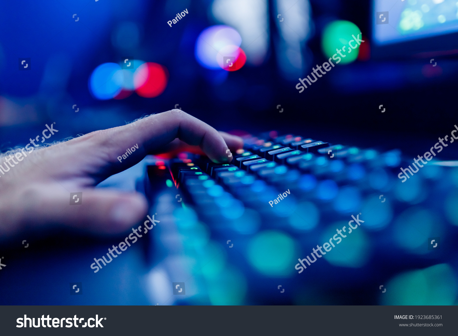 Professional cyber video gamer studio room with personal computer armchair  keyboard for stream in neon color blur background. Soft focus.