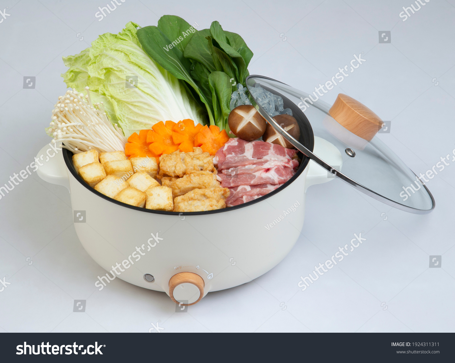 Electric pot and cover with vegetable and meat isolated on white ...
