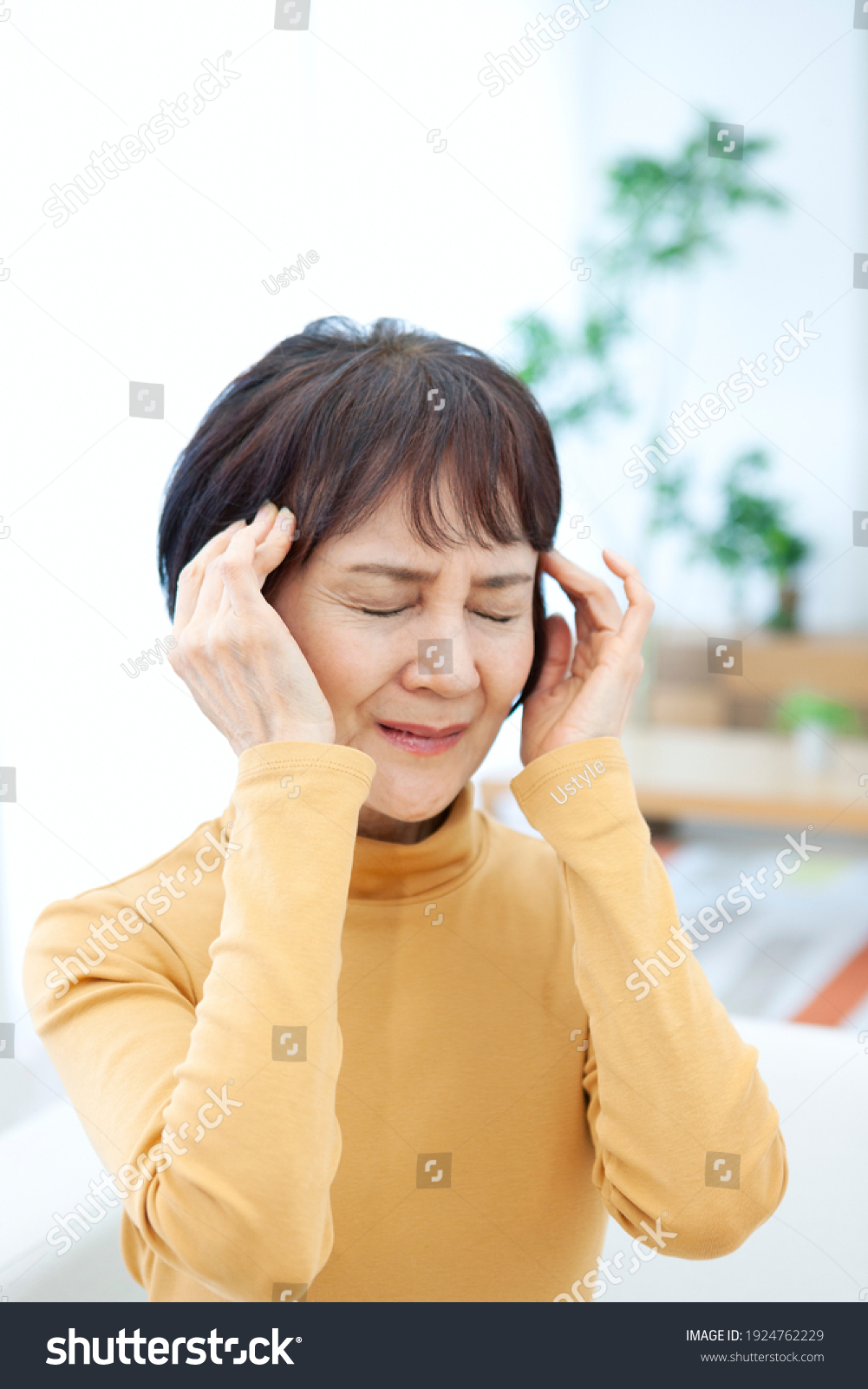 Senior woman holding her head