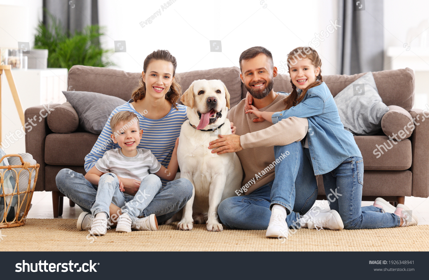 Smiling mother and father with little kids and adorable purebred ...