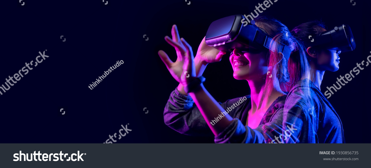 Future digital technology game and entertainment Teenager having fun play VR virtual reality goggle sport game 3D cyber space futuristic neon colorful background