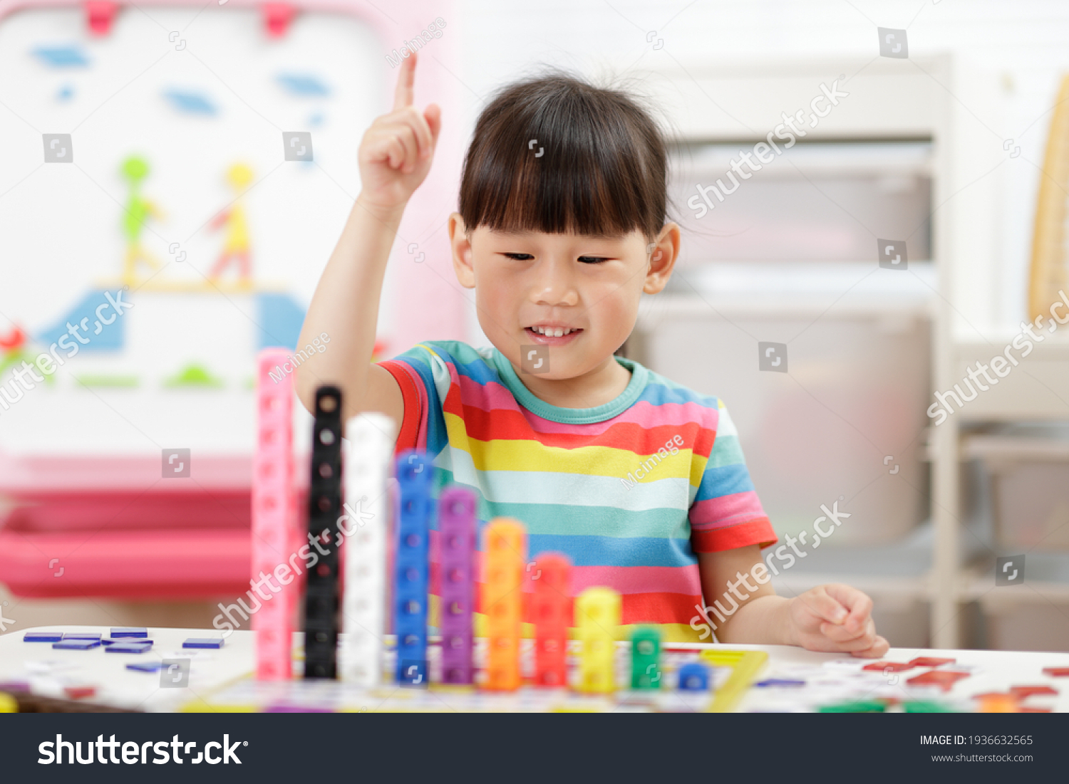 young girl play number blocks for home schooling 