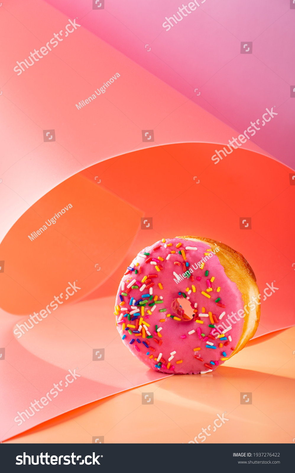 Donuts on pink and caramel swirled background with copy space