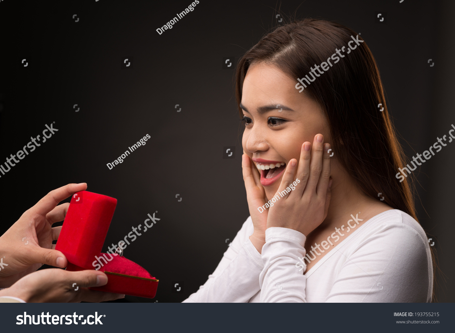 Portrait of surprised Asian woman looking at the gift box with a ring