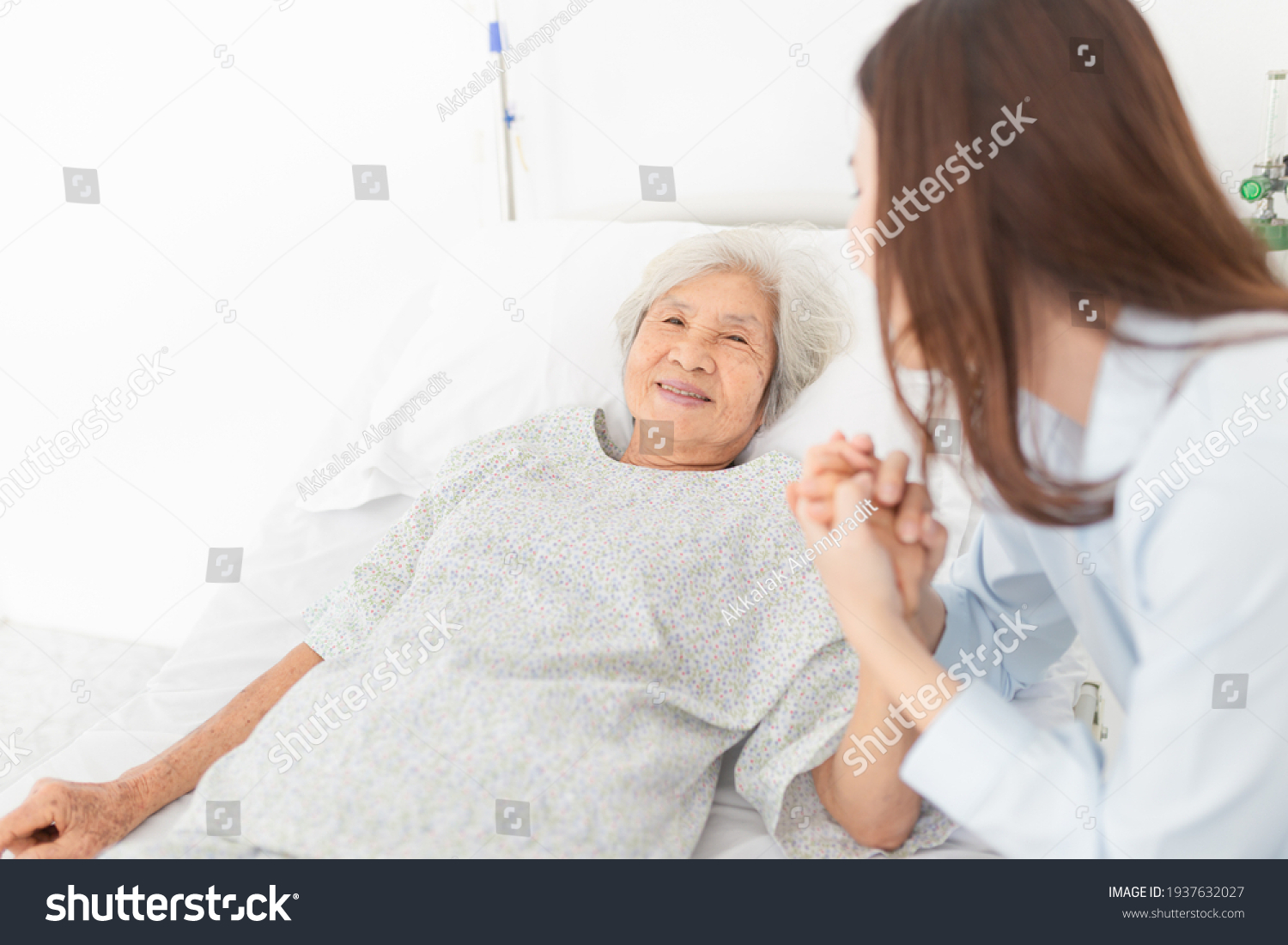close up old people old asian patient sick and admit in hospital young asian female visiting old female they holding hands together they feeling happy and smile elderly healthcare