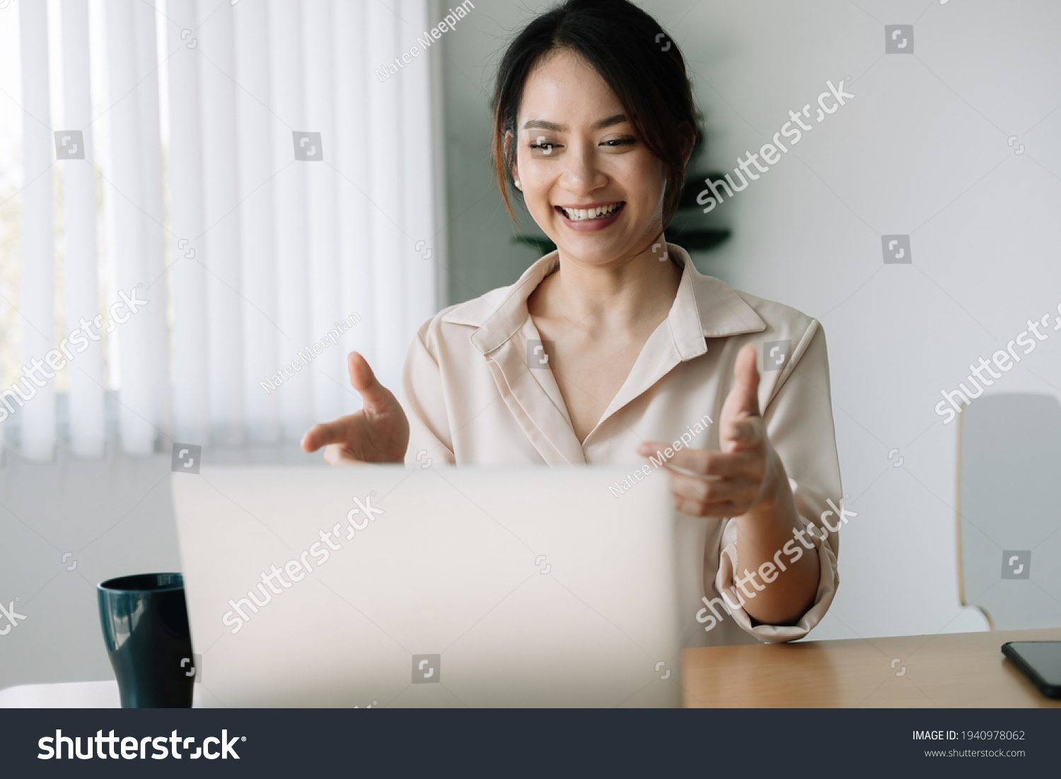 Asian woman watching webinar on laptop computer express opinion offer solution at virtual meeting. Student use pc and internet e-learning remotely
