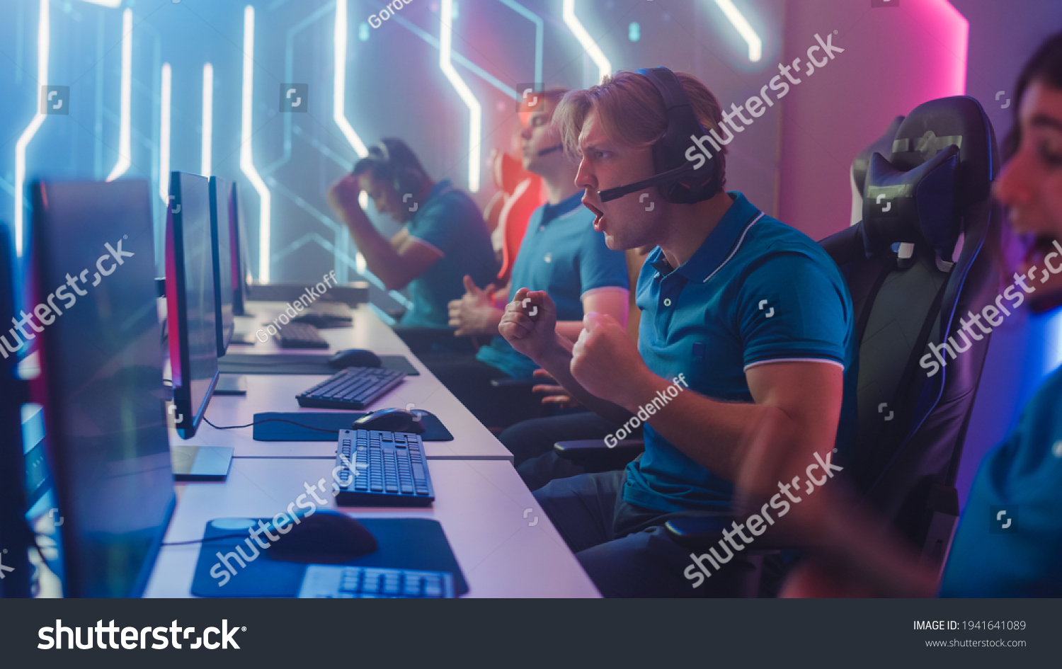 Diverse Esport Team of Pro Gamers Play in Computer Video Game and Win Championship  Celebrate with YES Gestures. Stylish Design Cyber Games Arena. Online Streaming of Tournament. Side View