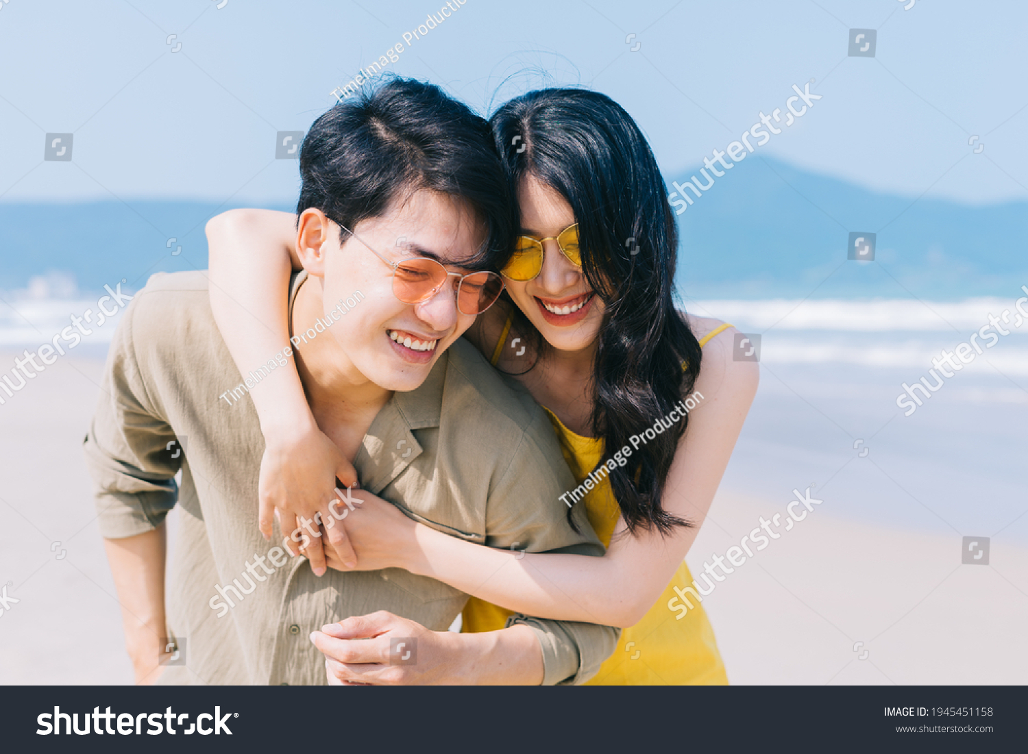 Young Asian couple enjoying summer vacation on the beach
