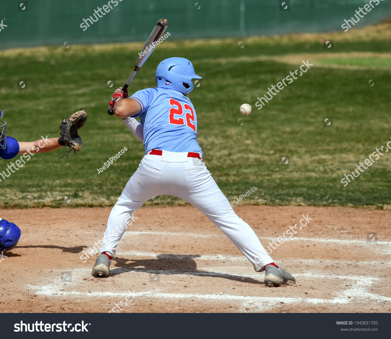 Action photo of high school baseball players making amazing plays during a baseball game