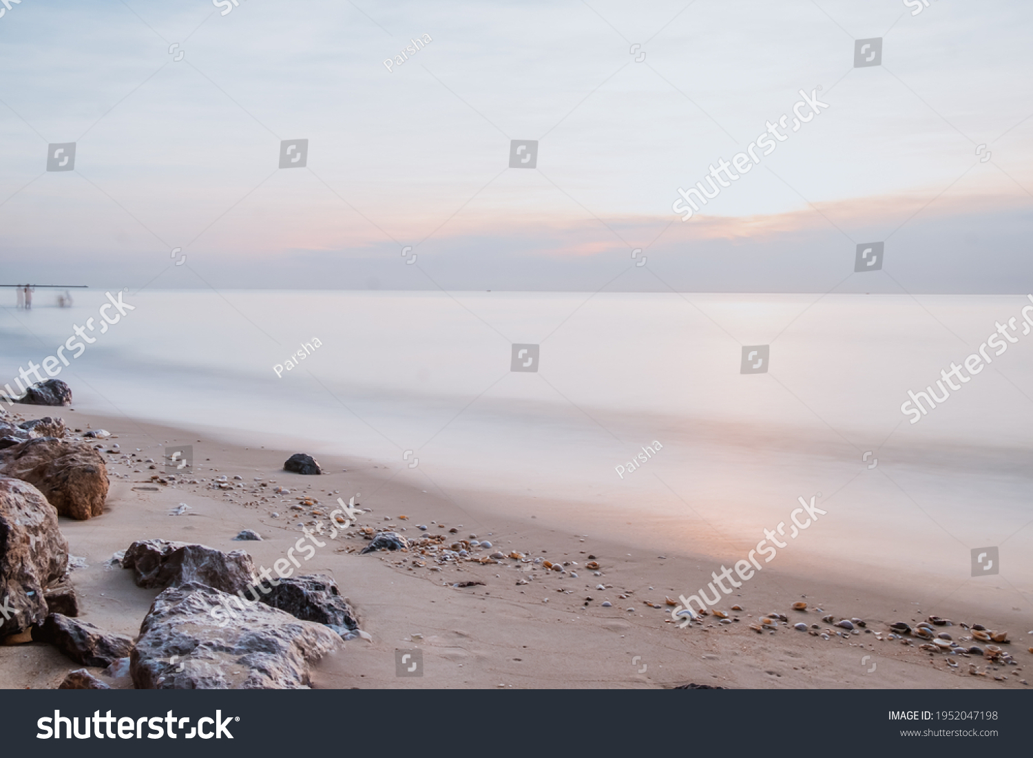 long exposure Sea rocks Magnificent sunrise view at sunrise Romantic atmosphere in peaceful morning at sea. Pink horizon with first hot sun rays.