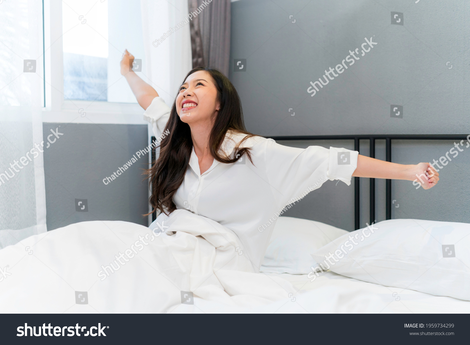 Asian woman feeling happy and fresh wake up in the morning.