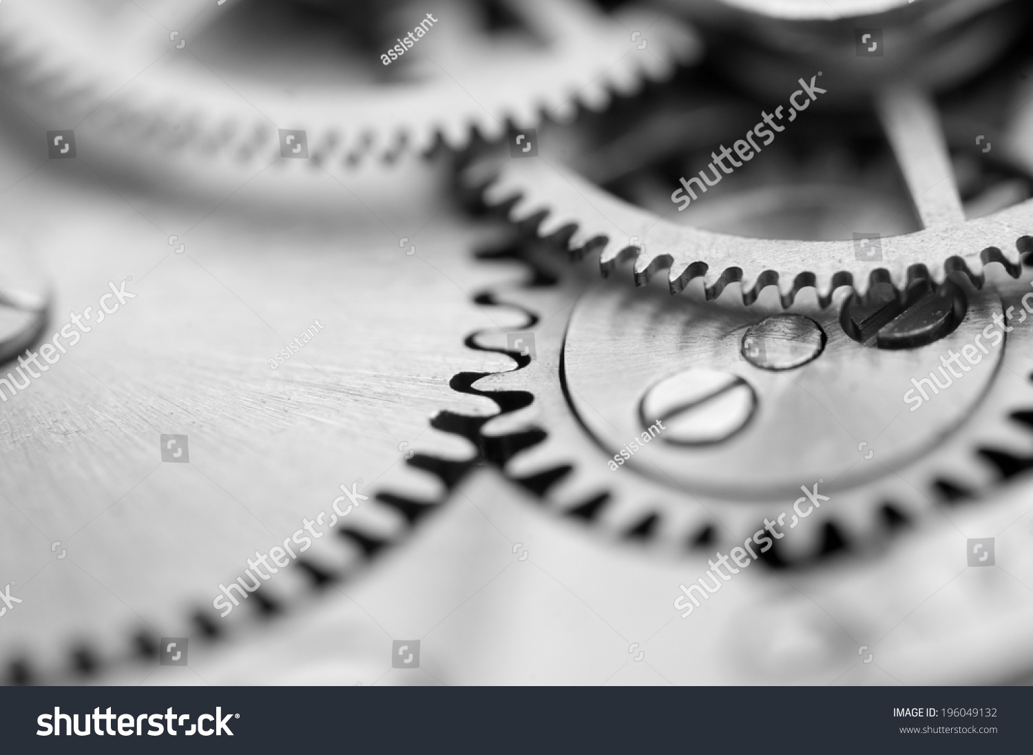 Black white background with metal cogwheels a clockwork. Macro