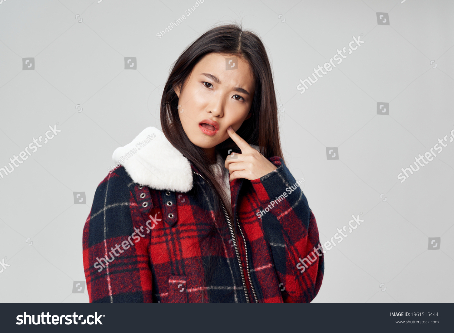 Asian woman in winter jacket plaid fabric model light background
