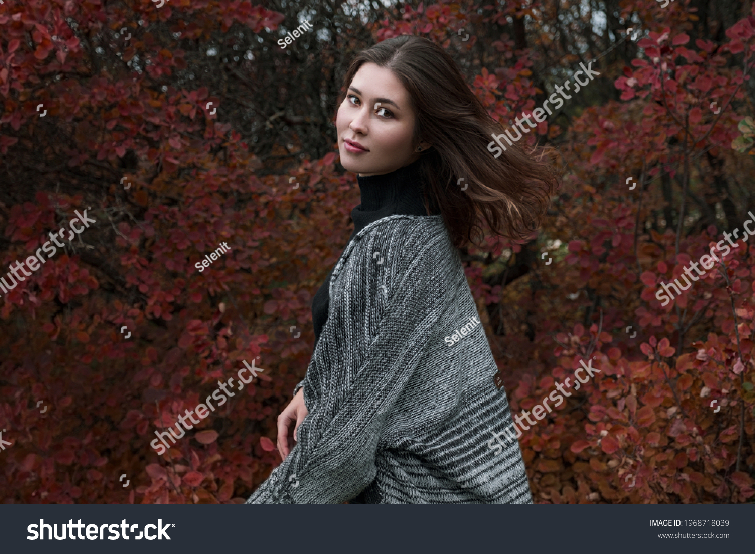 Close up portrait of a young asian woman outdoor. Autumn warm concept.